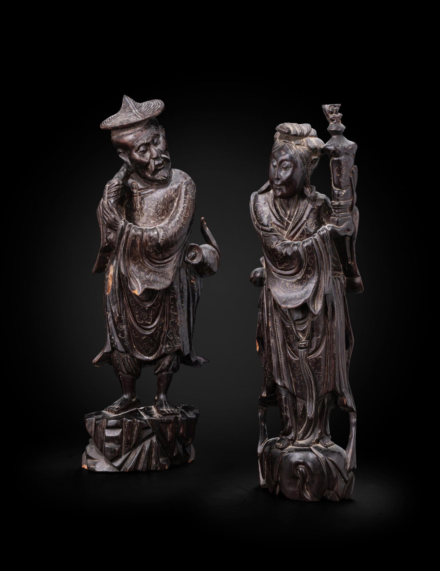 Two silver-filigree inlaid hardwood figures