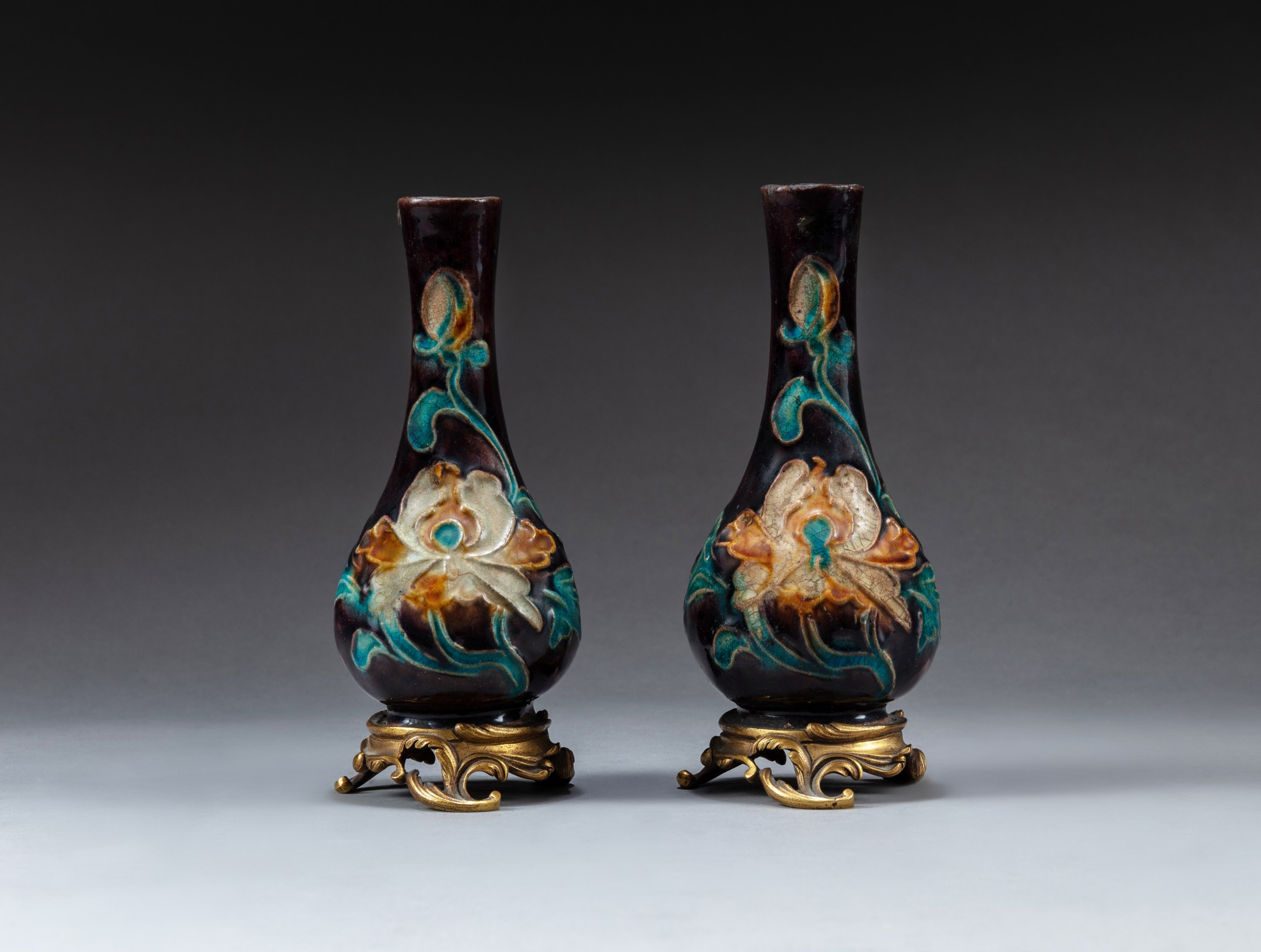 Two small fahua 'lotus' bottle vases