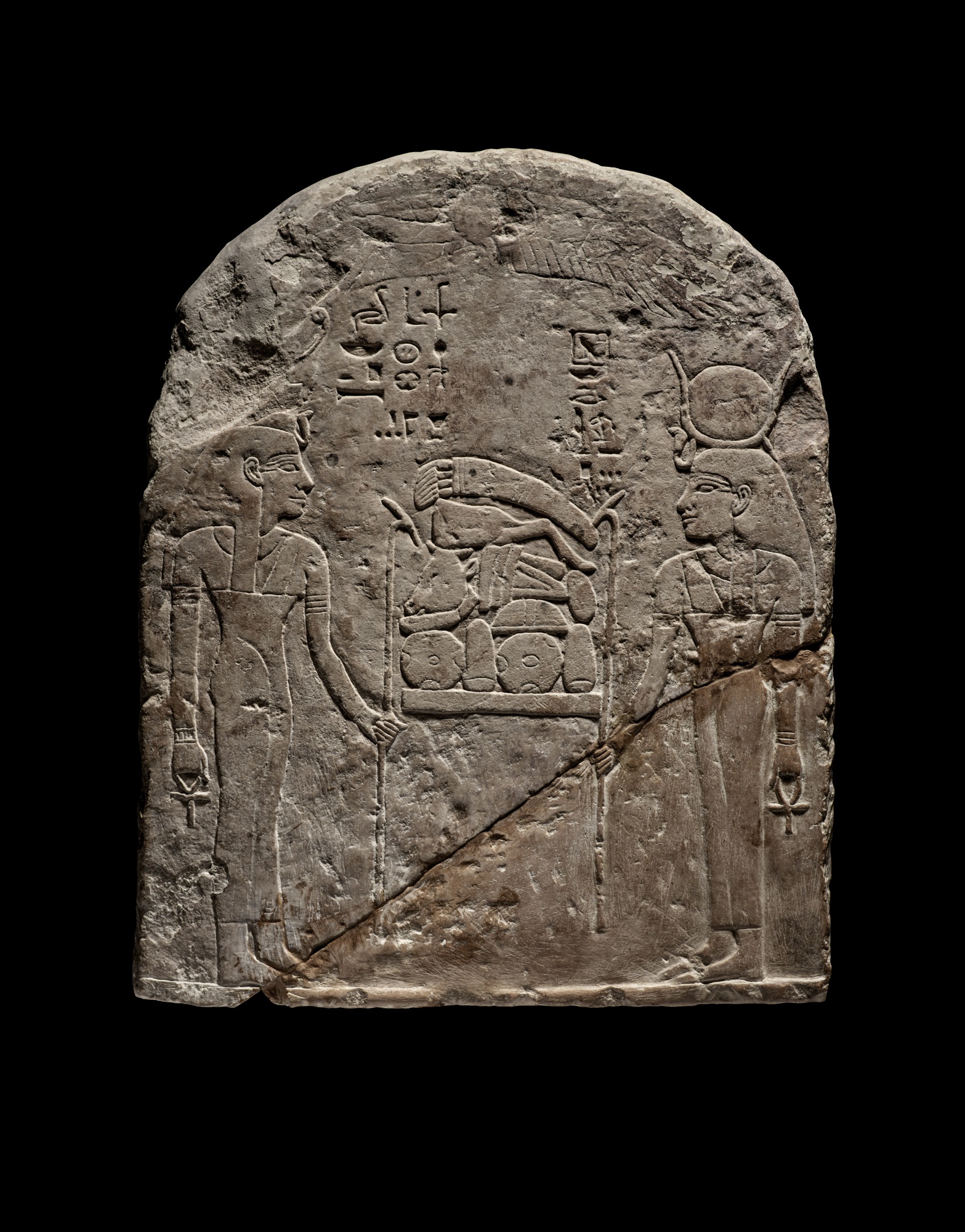 An Egyptian Limestone Round-topped Stela