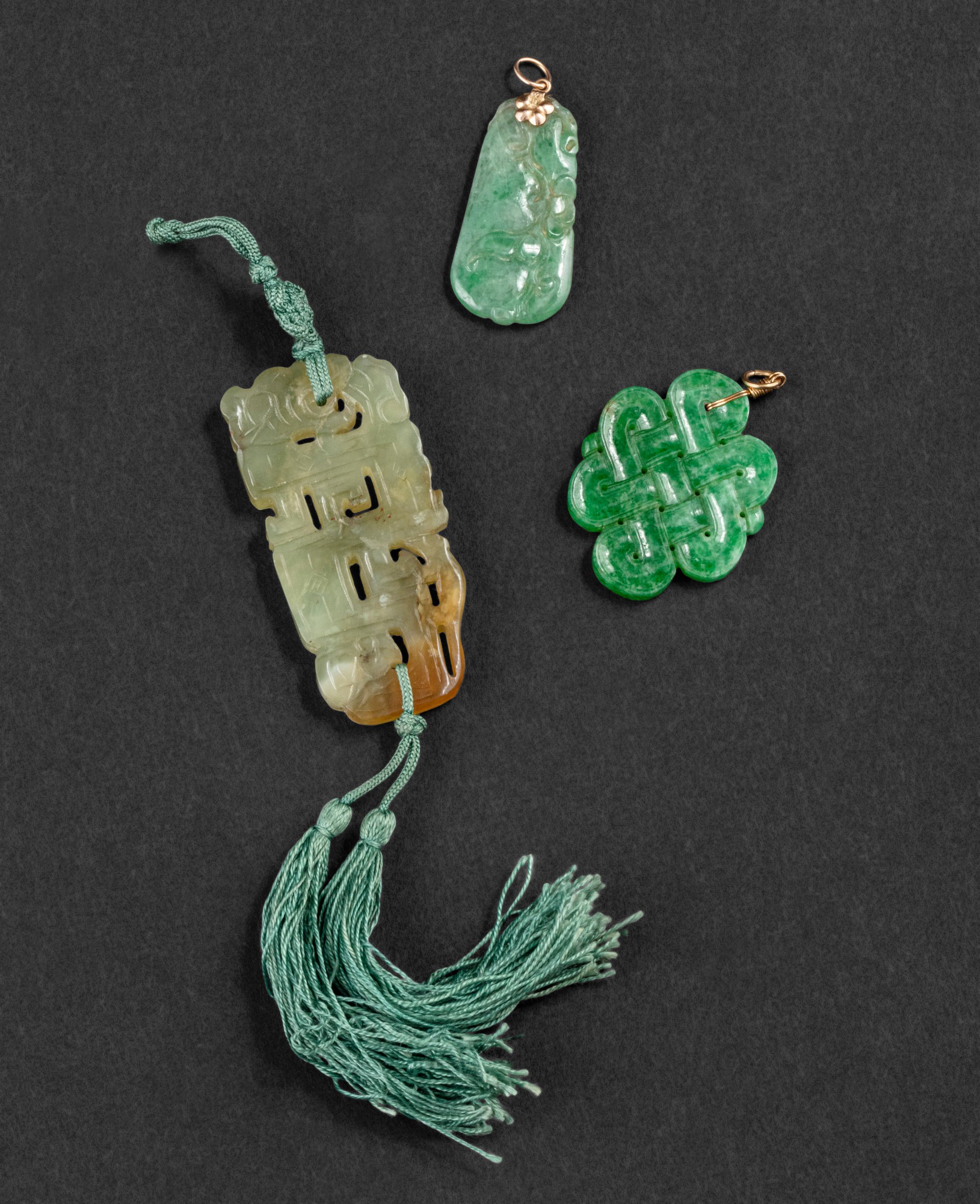 Two jadeite and a nephrite pendants