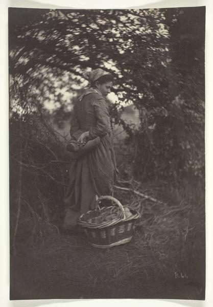 Woman Standing with Basket on Ground
