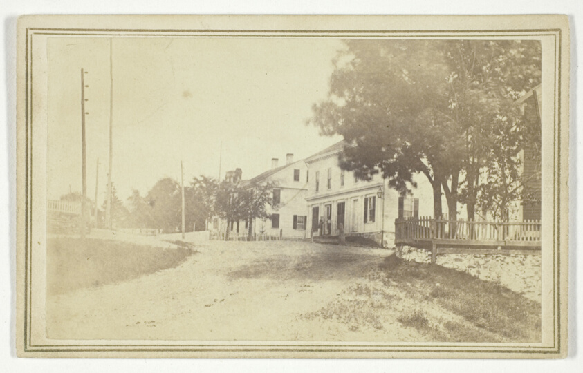 T. Holmes — Untitled (view of road with white clapboard houses)