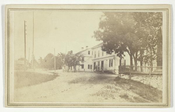 Untitled (view of road with white clapboard houses)