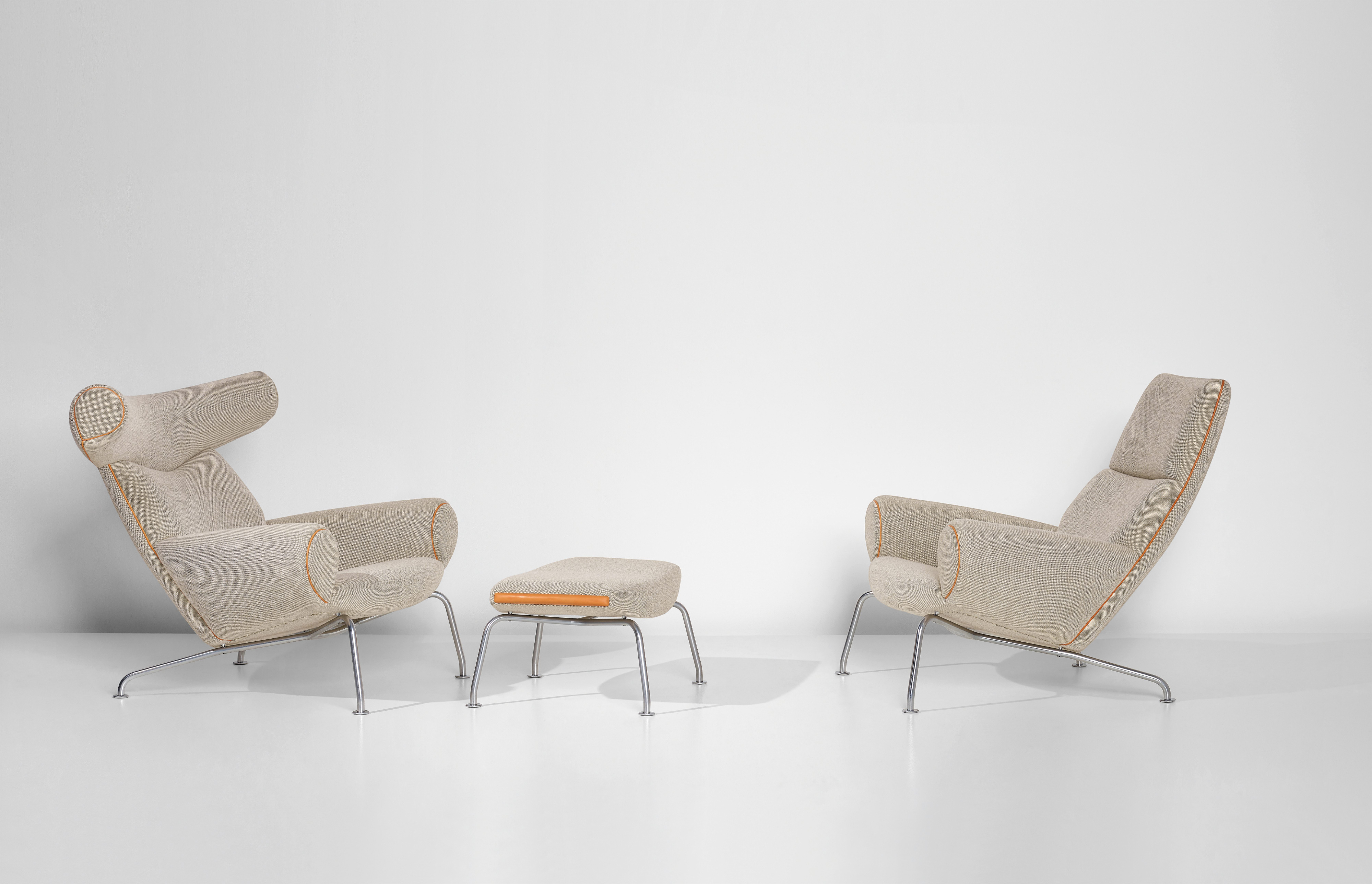 Hans J. Wegner — Two 'Ox' lounge armchairs, model nos. AP-46 and AP-47, and footstool, model no. AP-49