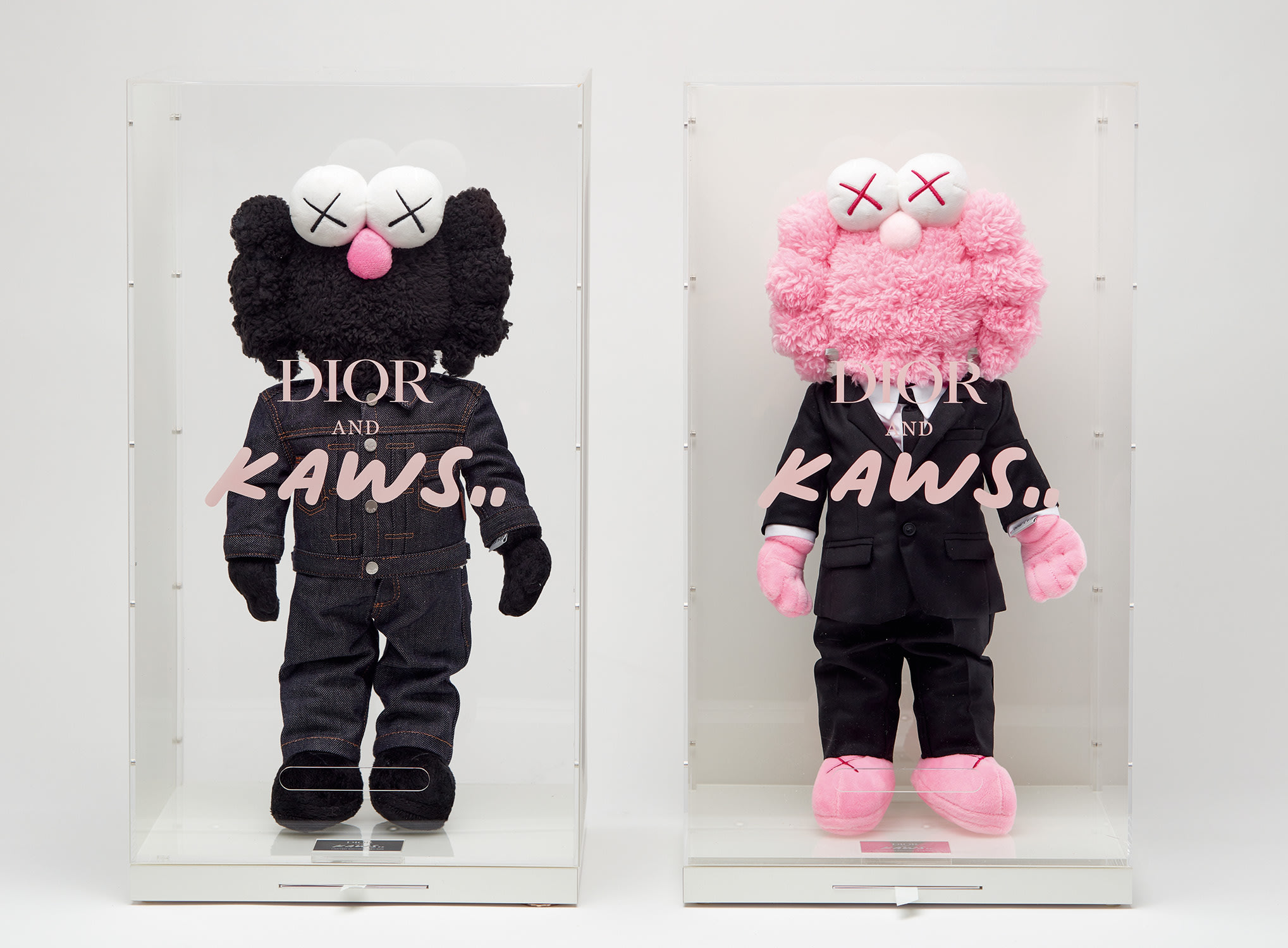 KAWS — embroidered with the artist's name 'KAWS..' on the underside of each plush; further embroidered with the edition number (i) '294/500' and (ii) '243/500' on a fabric label affixed to each figure's left hand