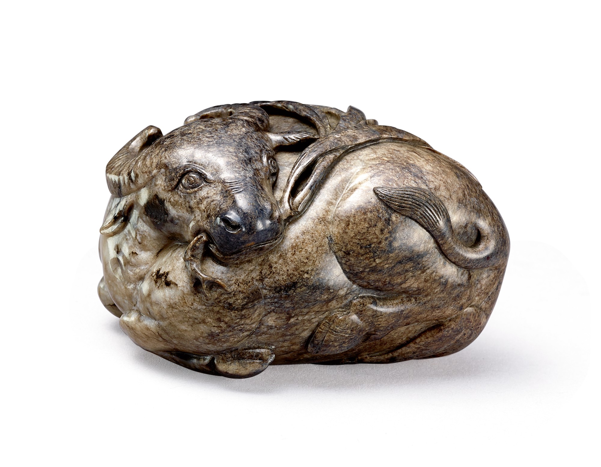 A grey jade carving of a buffalo — 明 灰玉圓雕臥牛