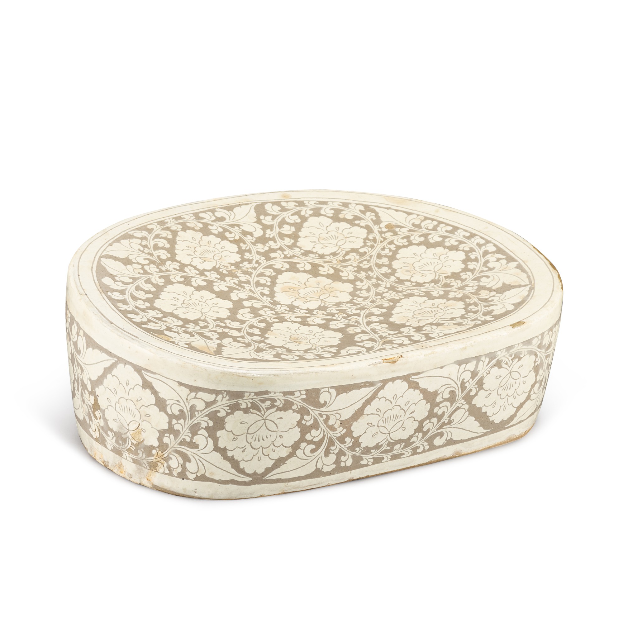 A Cizhou sgraffiato 'peony' pillow, — A Cizhou sgraffiato 'peony' pillow, Jin - Yuan dynasty 金至元 磁州白釉剔牡丹紋枕