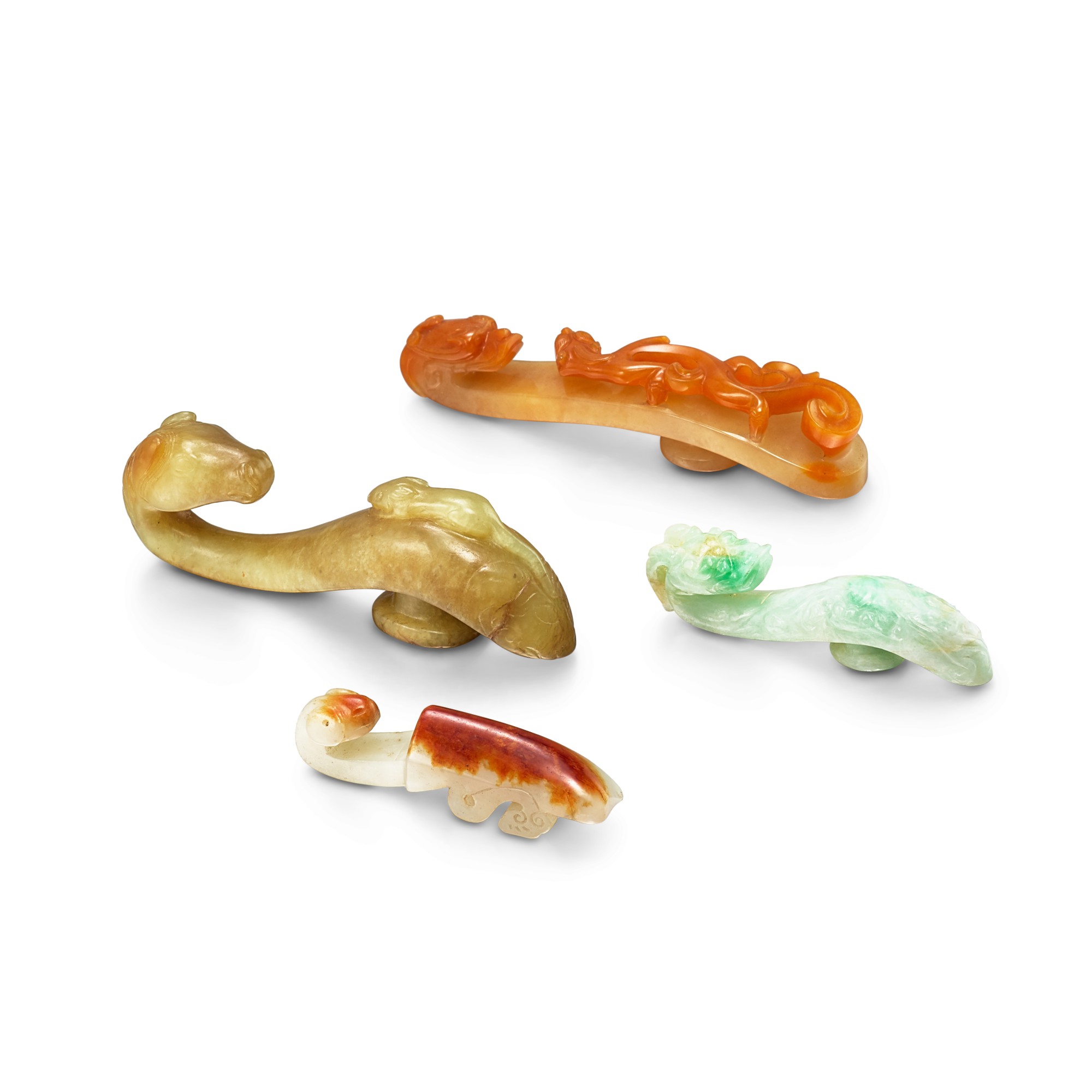 A jadeite, an agate and two jade belthooks — A jadeite, an agate and two jade belthooks, Qing dynasty  清 翠玉、瑪瑙及玉帶鉤一組四件