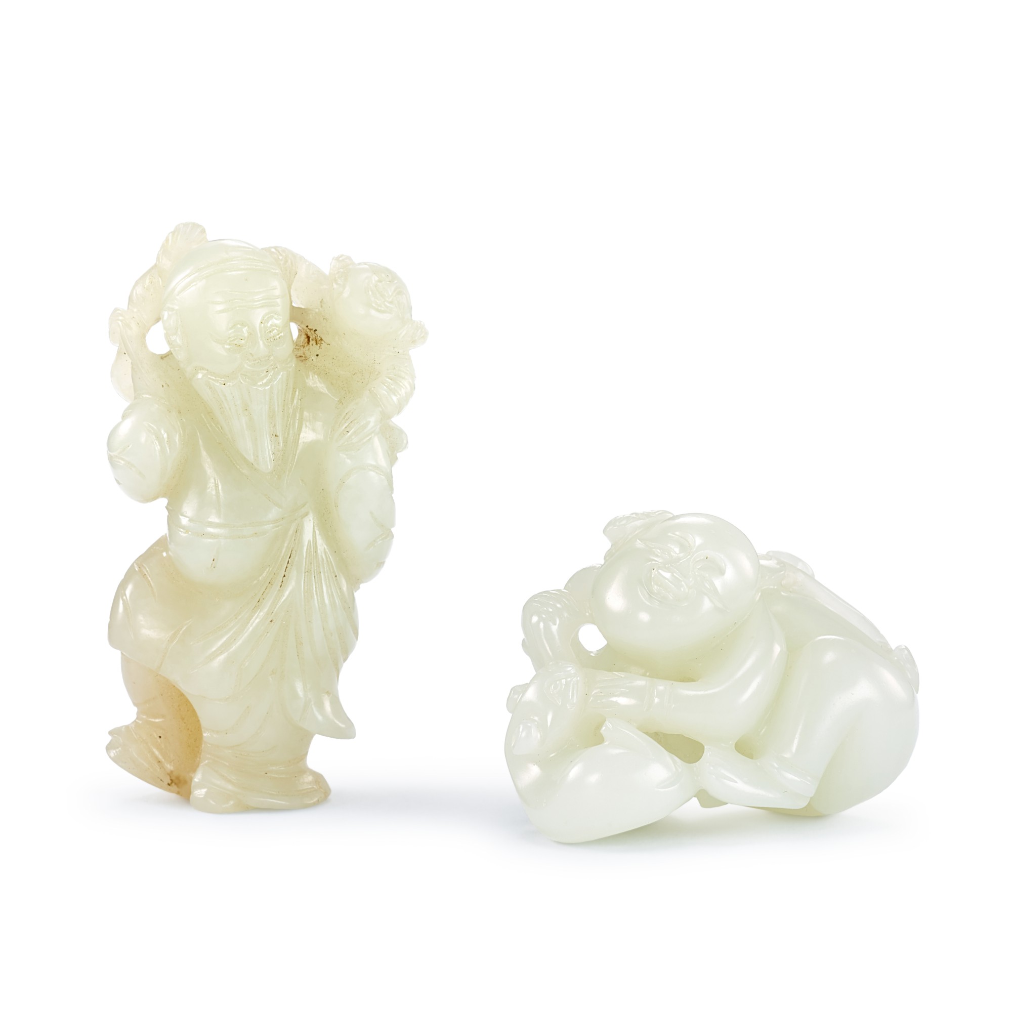 A pale celadon jade 'immortal and boy' group and a white jade ‘boy and cat’ group, Qing dynasty, 19th century 清十九世紀 青白玉仙人童子 及 白玉童子戲貓一組兩件