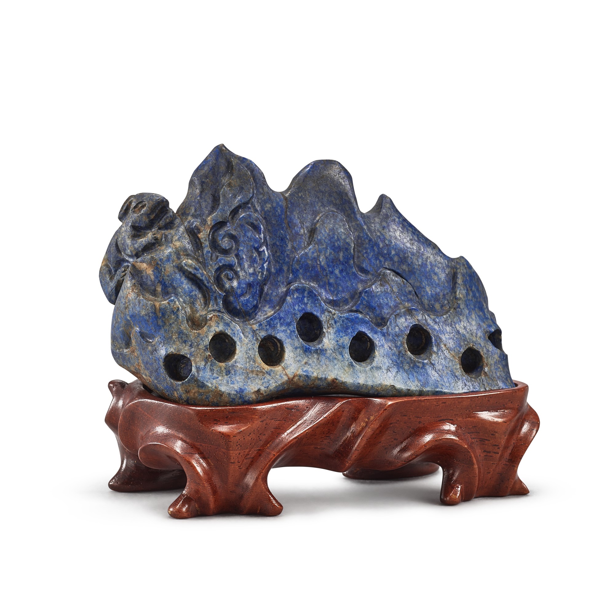 A carved lapis lazuli 'rabbit and lingzhi' boulder, — A carved lapis lazuli 'rabbit and lingzhi' boulder, Qing dynasty, 19th century 清十九世紀 青金石瑞兔靈芝圖山子