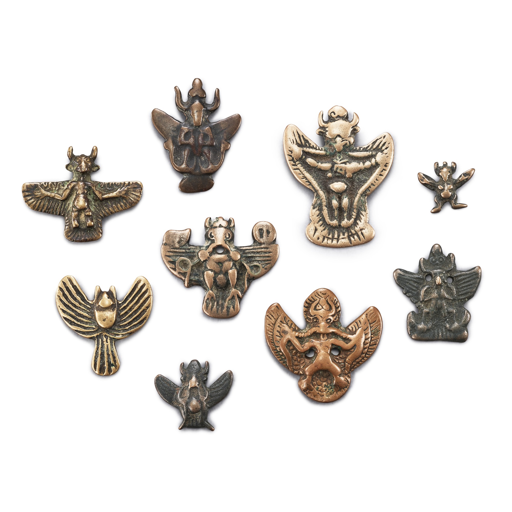 A group of 9 copper-alloy 'Khyung' thogchags, — A group of 9 copper-alloy 'Khyung' thogchags, Tibet, 12th - 15th century 十二至十五世紀 西藏 大鵬金翅鳥紋天鐵一組九件