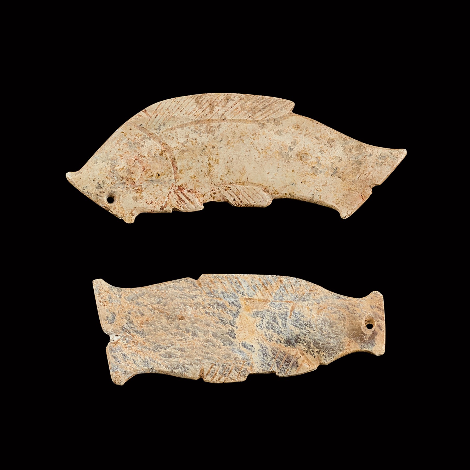 Two calcified jade ‘fish’ pendants — 西周 玉魚形珮兩件