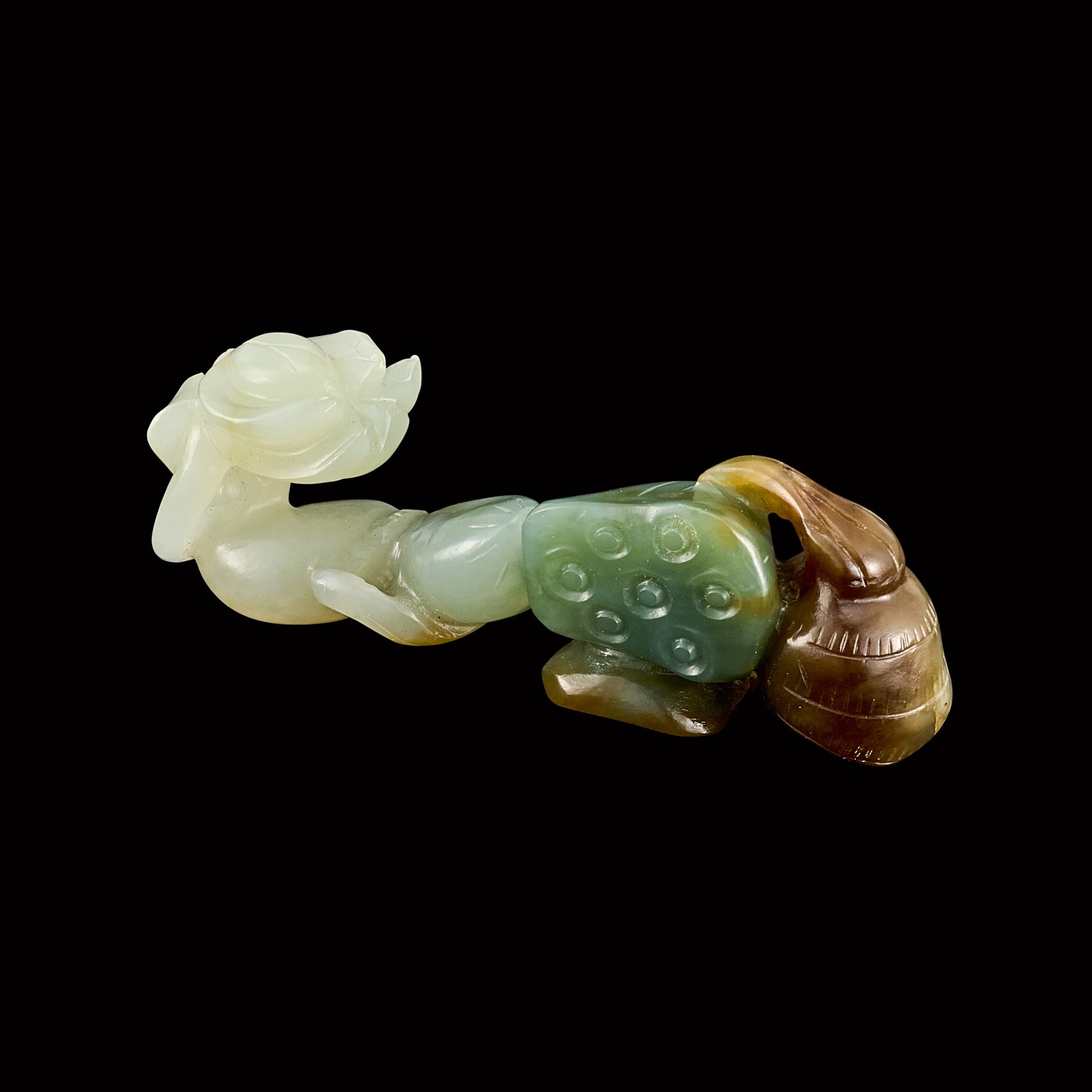 A variegated jade 'lotus root' belt buckle — 清十九世紀 白玉巧色蓮藕帶鉤