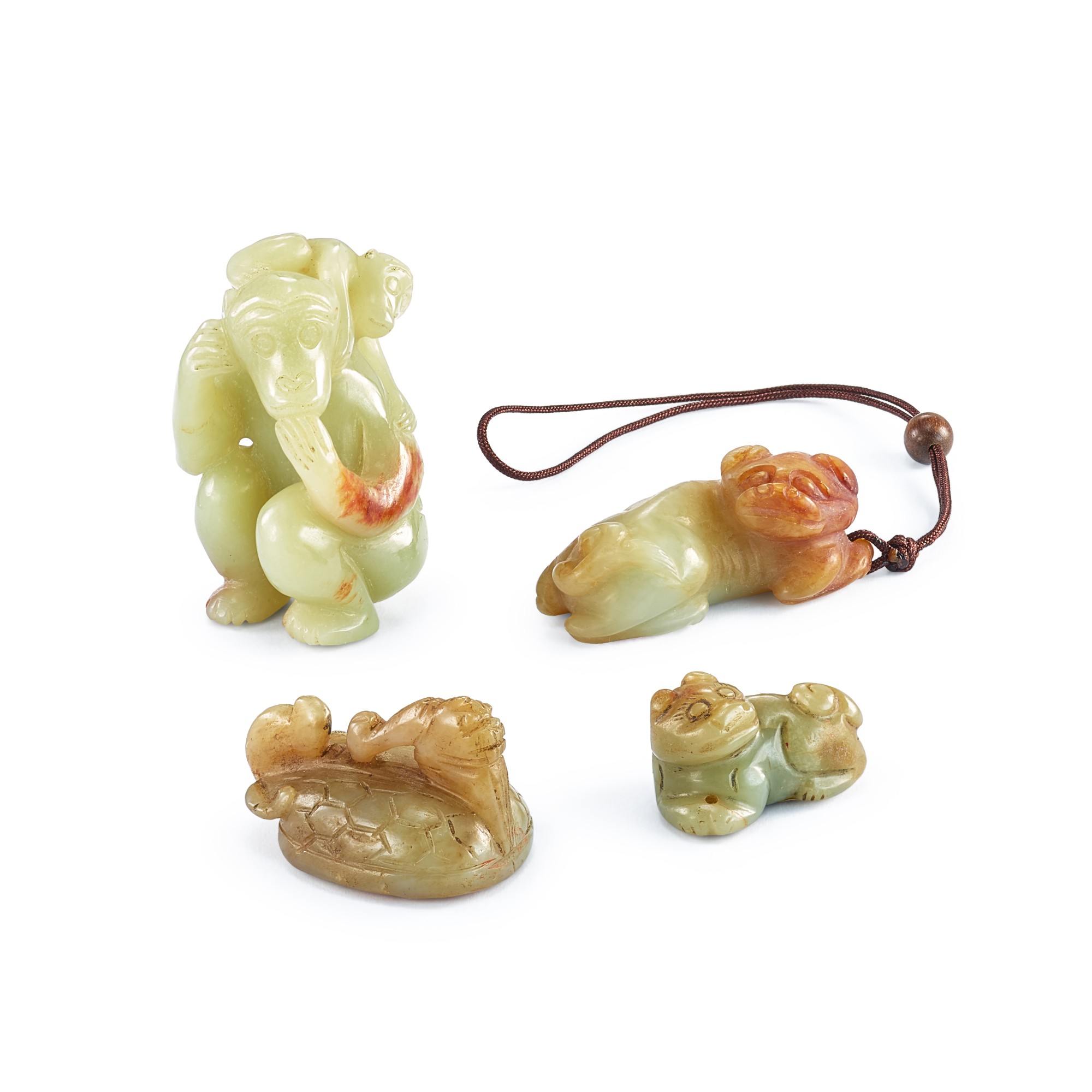 Four celadon and russet jade animal carvings, — Four celadon and russet jade animal carvings, Ming dynasty or later 明或以後 青玉瑞獸一組四件