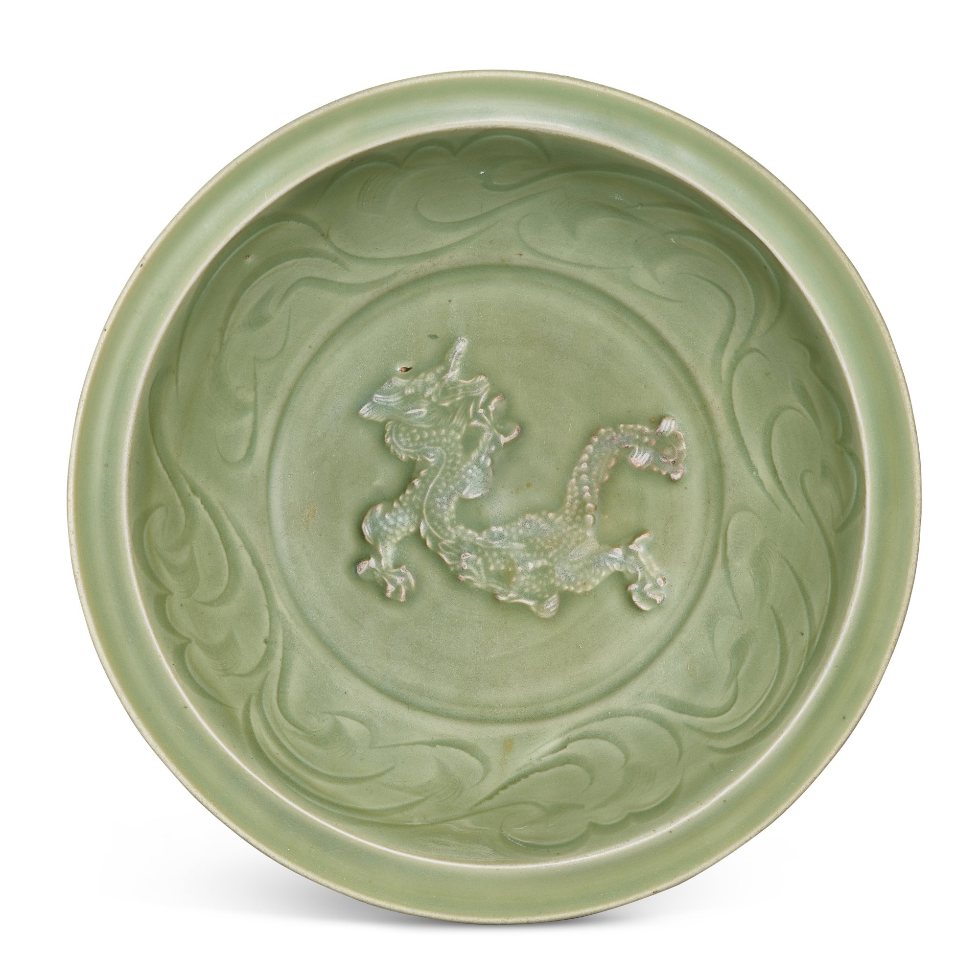 A Longquan celadon 'dragon' charger, — A Longquan celadon 'dragon' charger, Early Yuan dynasty 元初 龍泉青釉刻花貼龍紋折沿大盤