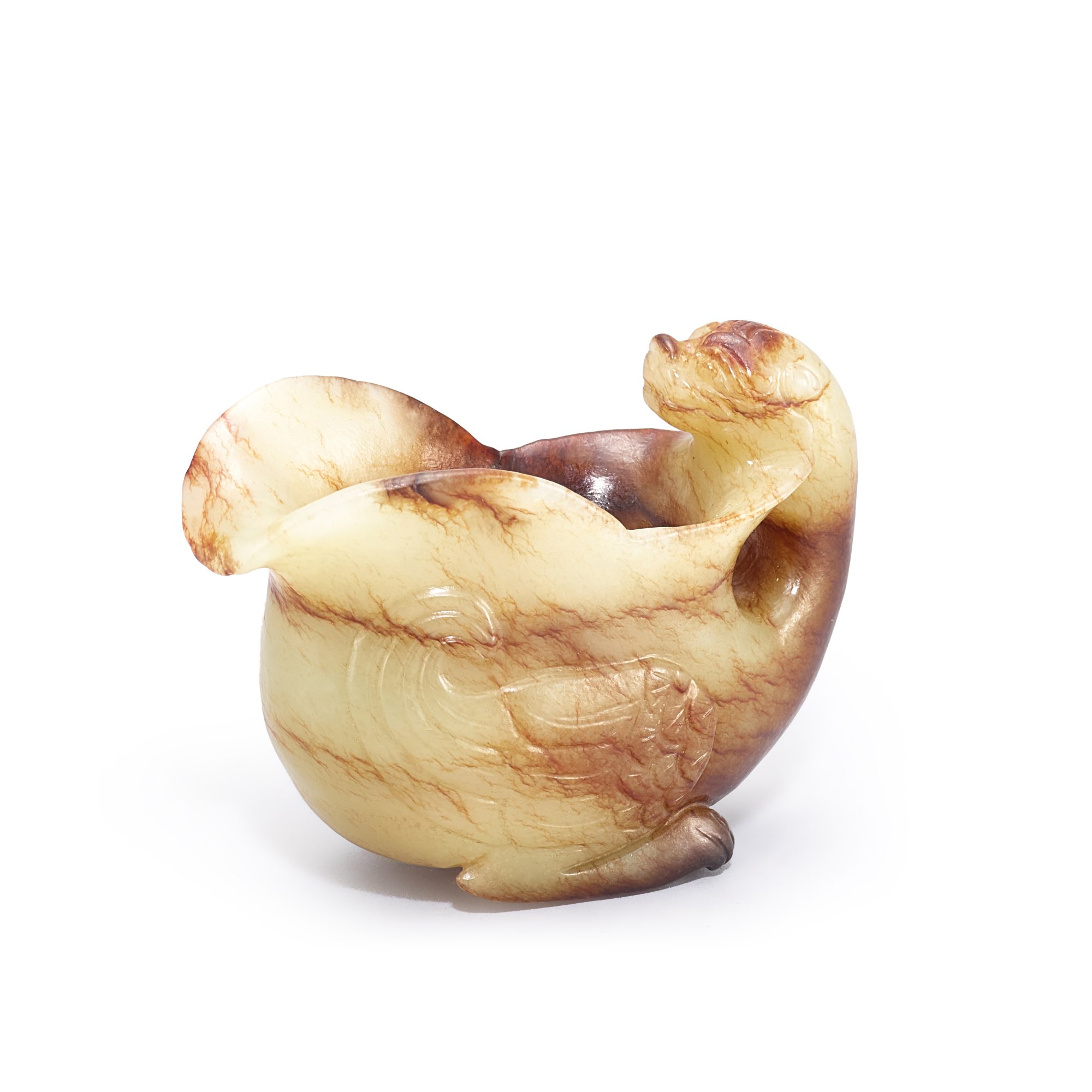 A jade 'mythical beast' libation cup, — A jade 'mythical beast' libation cup, 17th - 18th century 十七至十八世紀 玉雕臥獸式盃