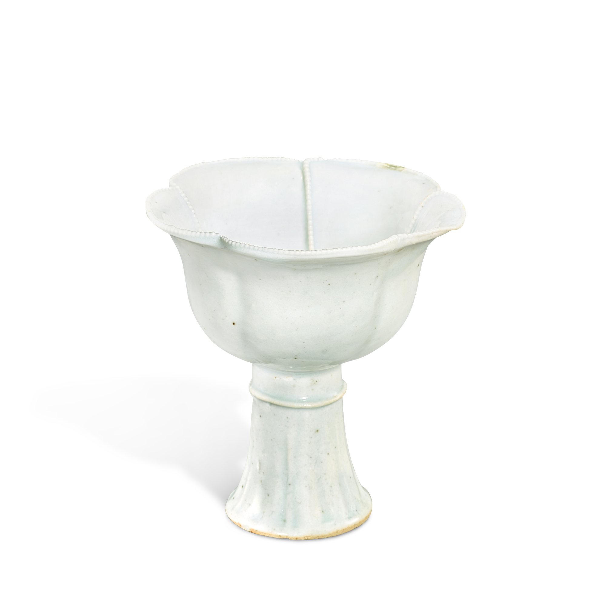 A rare qingbai 'prunus' lobed stemcup, — A rare qingbai 'prunus' lobed stemcup, Yuan dynasty, 14th century 元十四世紀 青白釉貼花梅式高足盃