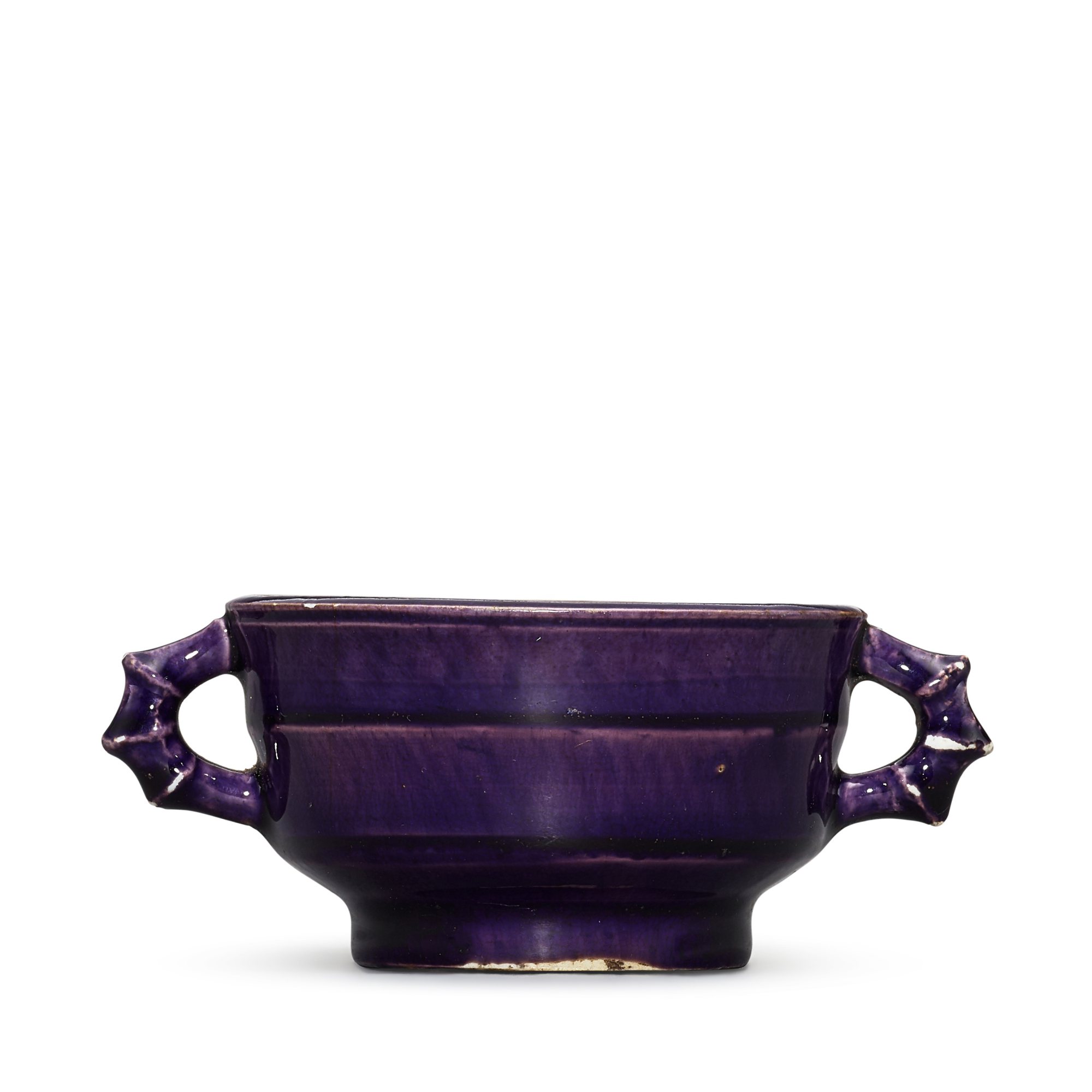 An aubergine-glazed 'bamboo' handled cup, — An aubergine-glazed 'bamboo' handled cup, Qing dynasty, Kangxi period 清康熙 茄皮紫釉竹節耳盃