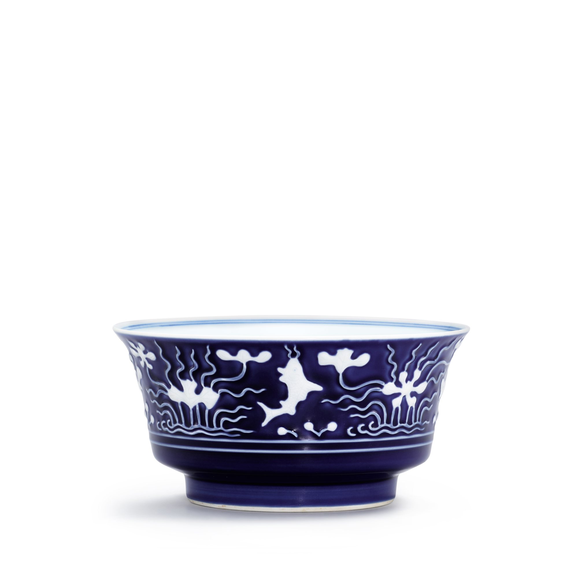 A slip-decorated blue-ground 'fish' bowl, — A slip-decorated blue-ground 'fish' bowl, Mark and period of Yongzheng 清雍正 藍地堆白花荷塘魚藻紋合盌 《大清雍正年製》款