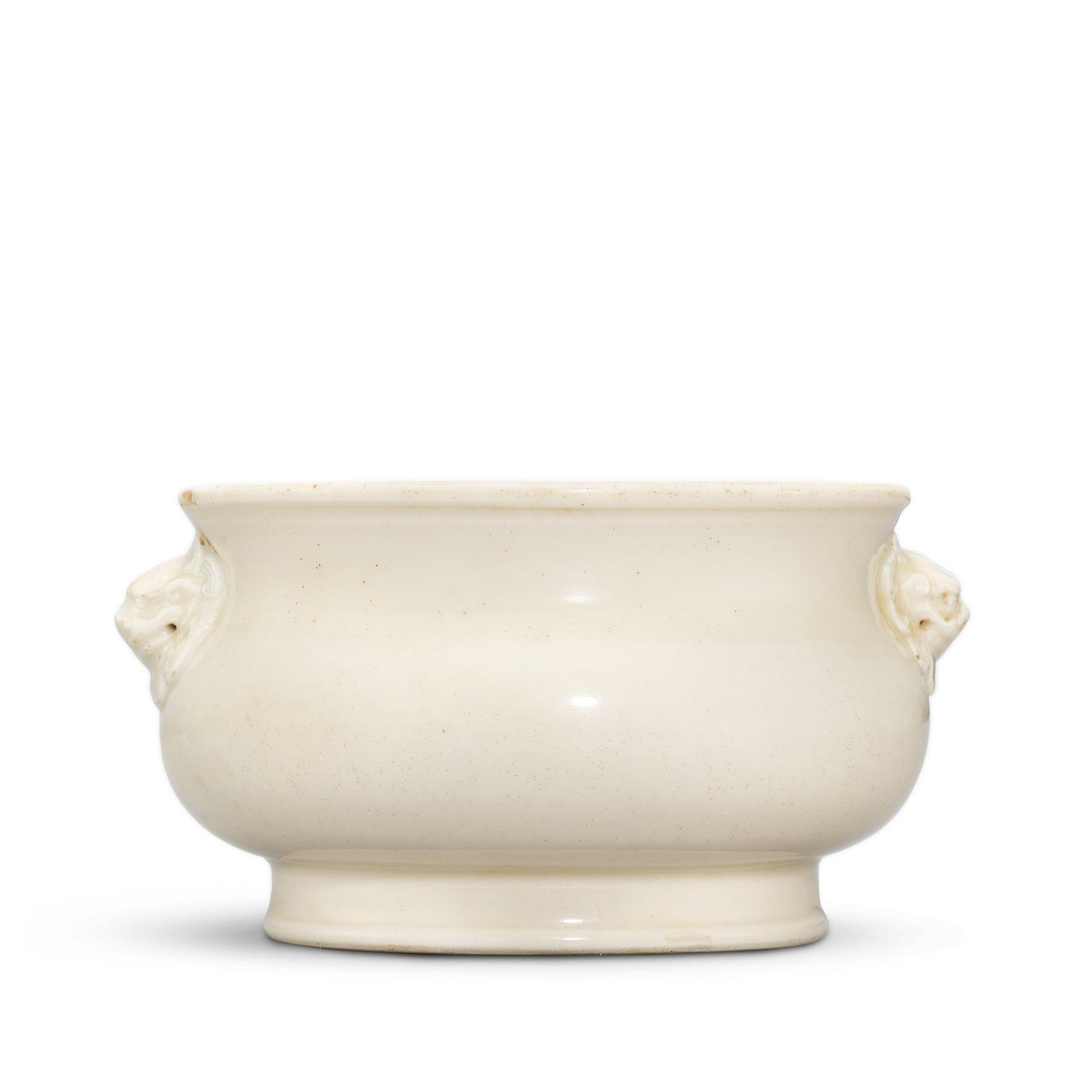 A Dehua lion-handled incense burner, — A Dehua lion-handled incense burner, 17th - 18th century 十七至十八世紀 德化白釉獅耳簋式爐