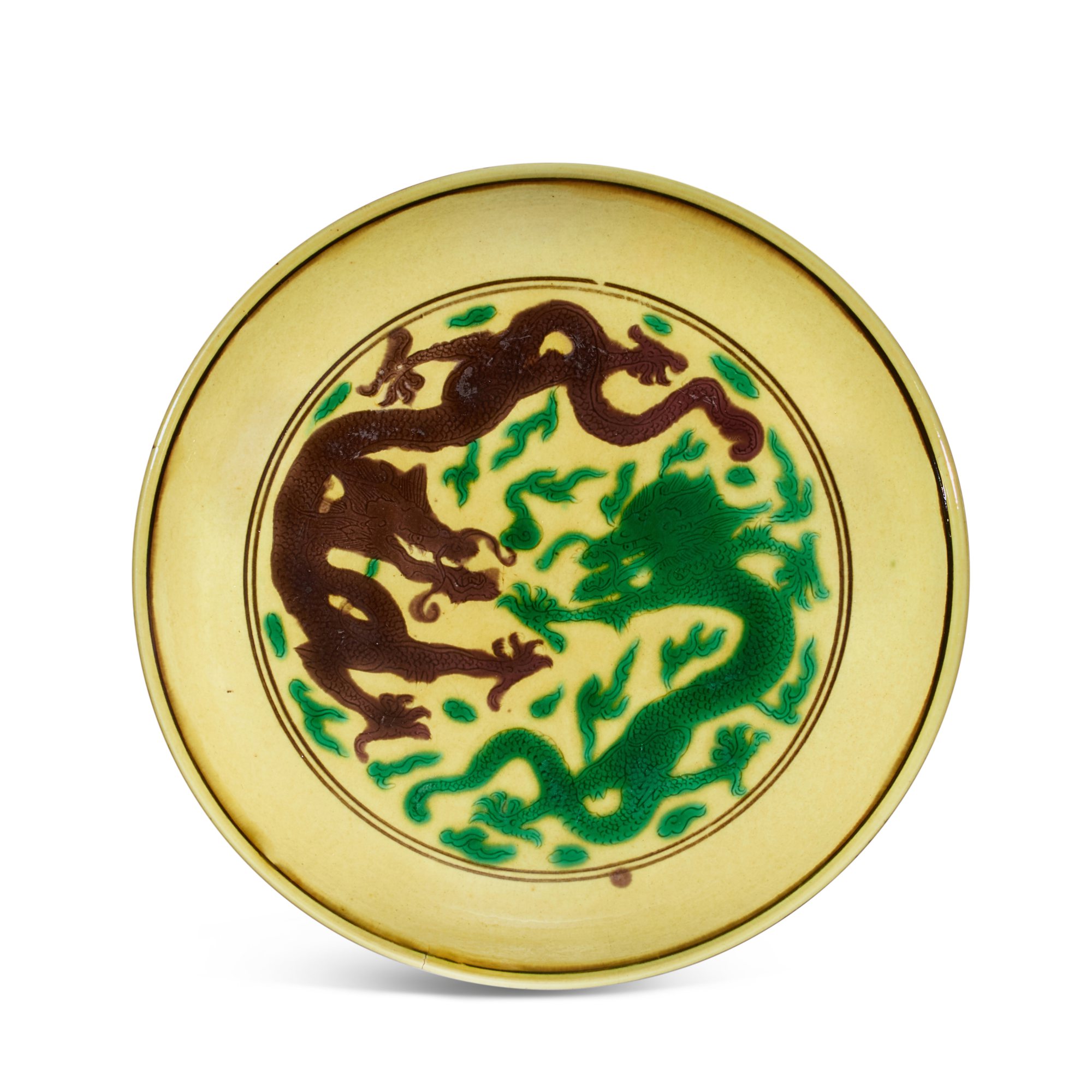 A yellow-ground green and aubergine-enamelled 'dragon' dish, — A yellow-ground green and aubergine-enamelled 'dragon' dish, Mark and period of Kangxi 清康熙 黃地紫綠彩葡萄雲龍紋盤 《大清康熙年製》款