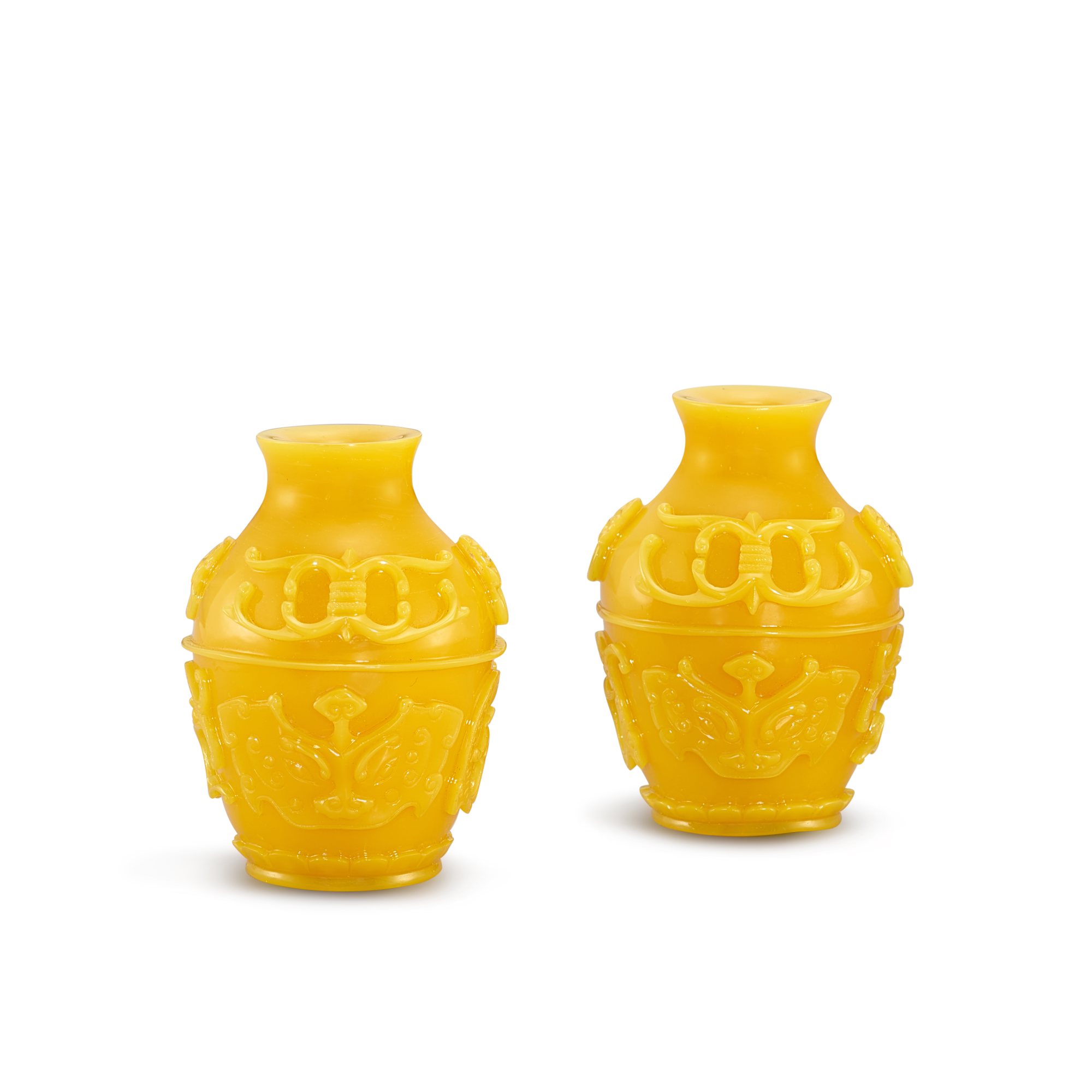 Unknown — A pair of carved archaistic opaque yellow glass miniature jars, Qing dynasty, 18th - 19th century 清十八至十九世紀 黃料饕餮龍鳳紋小瓶一對 《乾隆年製》款