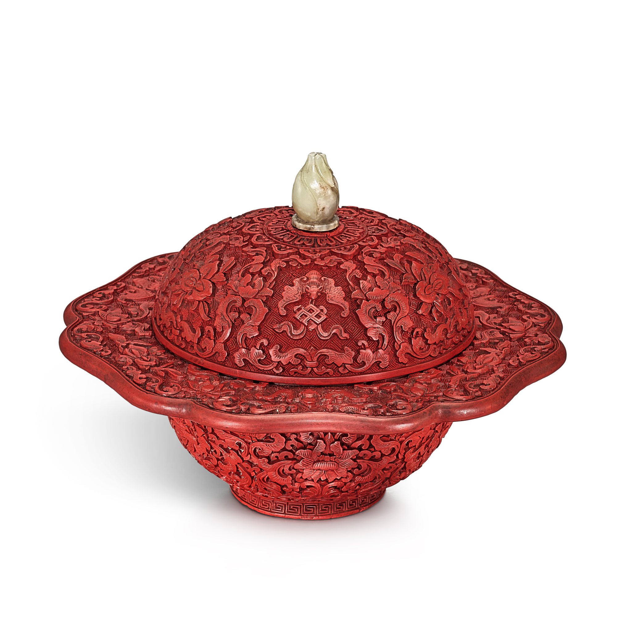 A carved cinnabar lacquer spittoon and cover, — A carved cinnabar lacquer spittoon and cover, Qing dynasty, Qianlong period 清乾隆 剔紅纏枝蓮紋葵花式唾盂