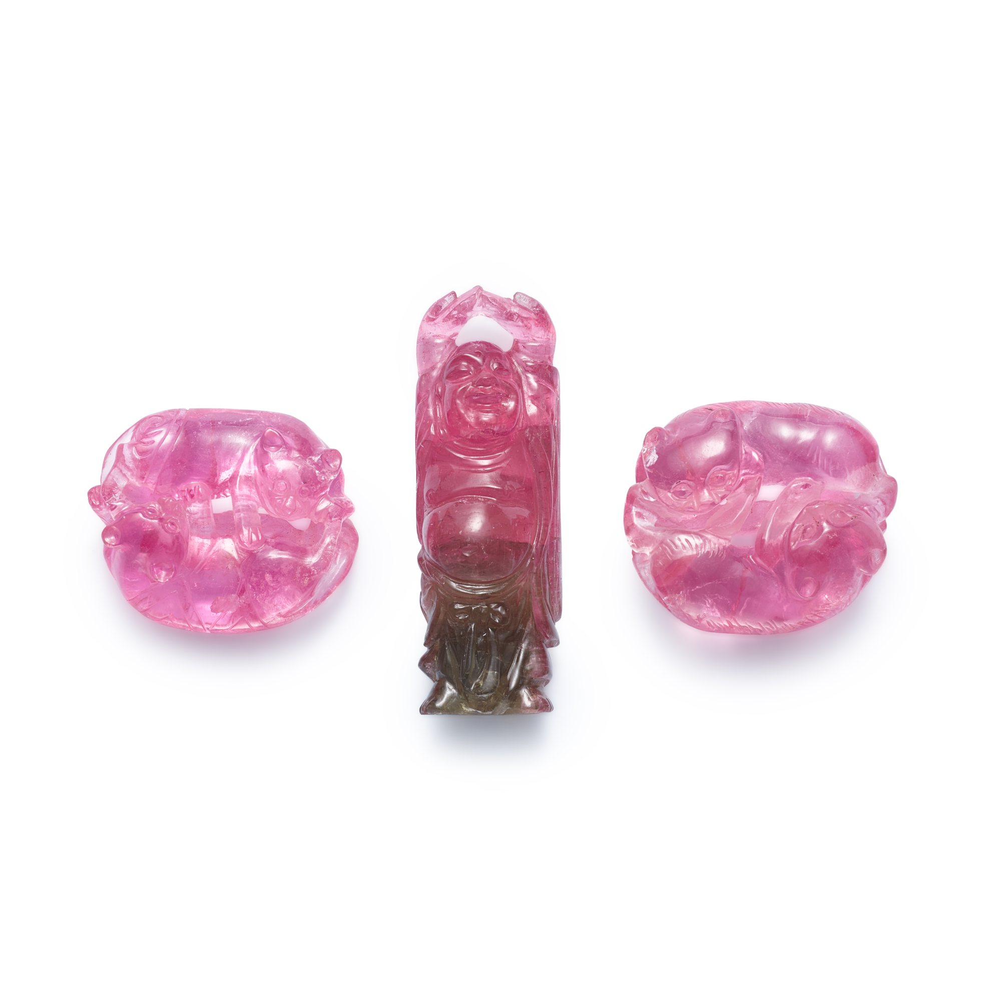 Three carved tourmaline pendants,