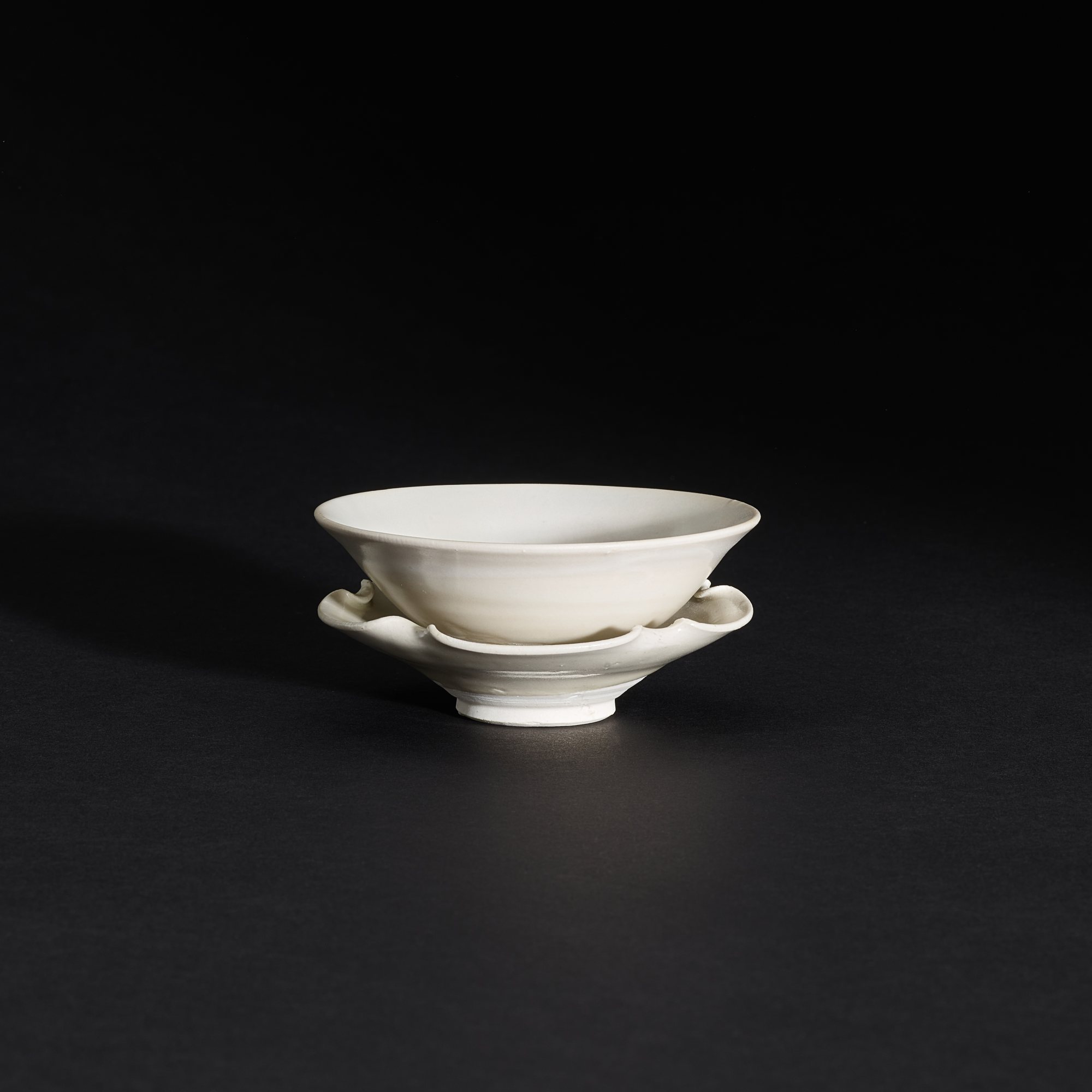 A Xingyao white-glazed teabowl and stand, — A Xingyao white-glazed teabowl and stand, Five dynasties 五代 邢窰白釉茶盌及花口盞托