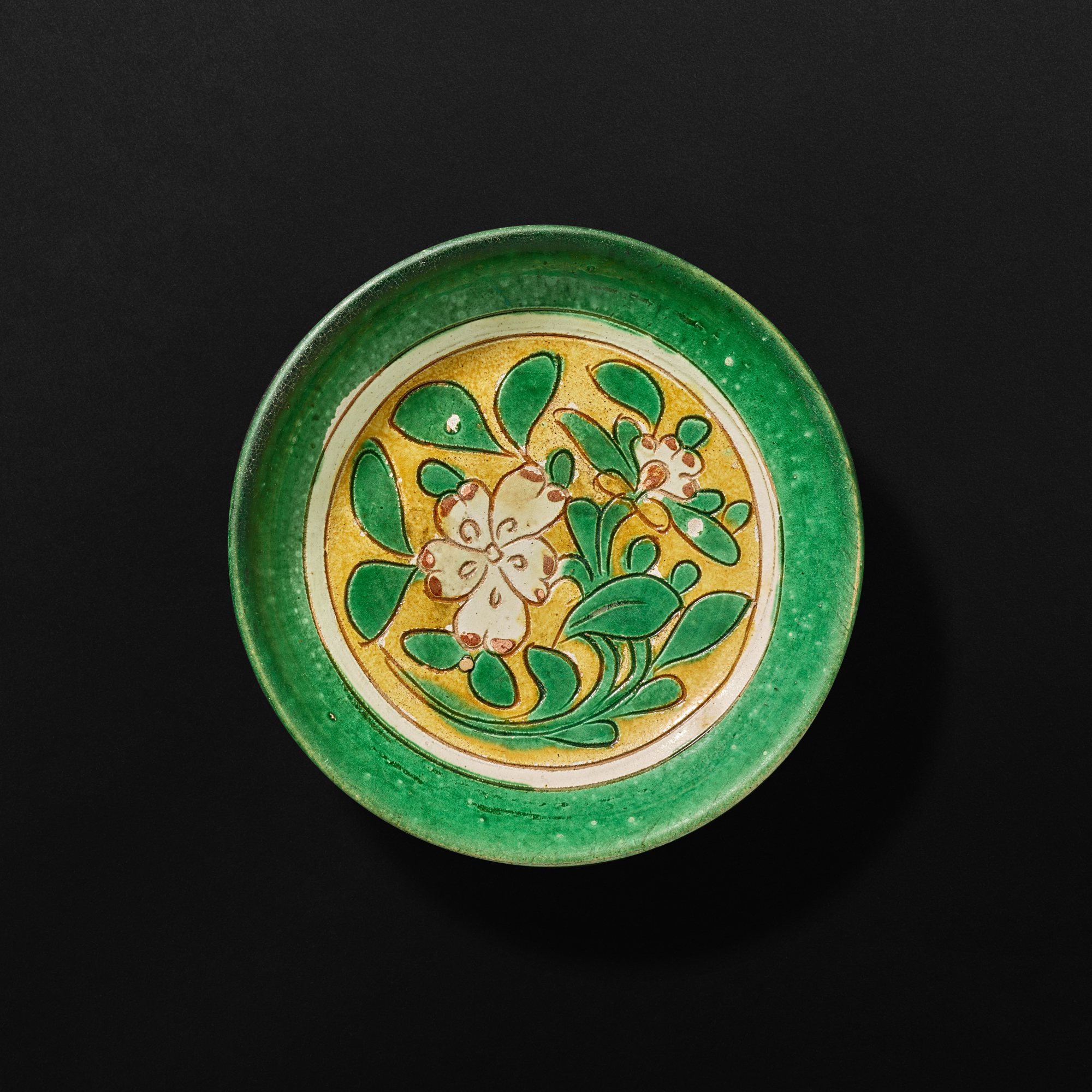 A sancai ‘floral’ dish, — A sancai ‘floral’ dish, Liao dynasty 遼 三彩花卉紋盤