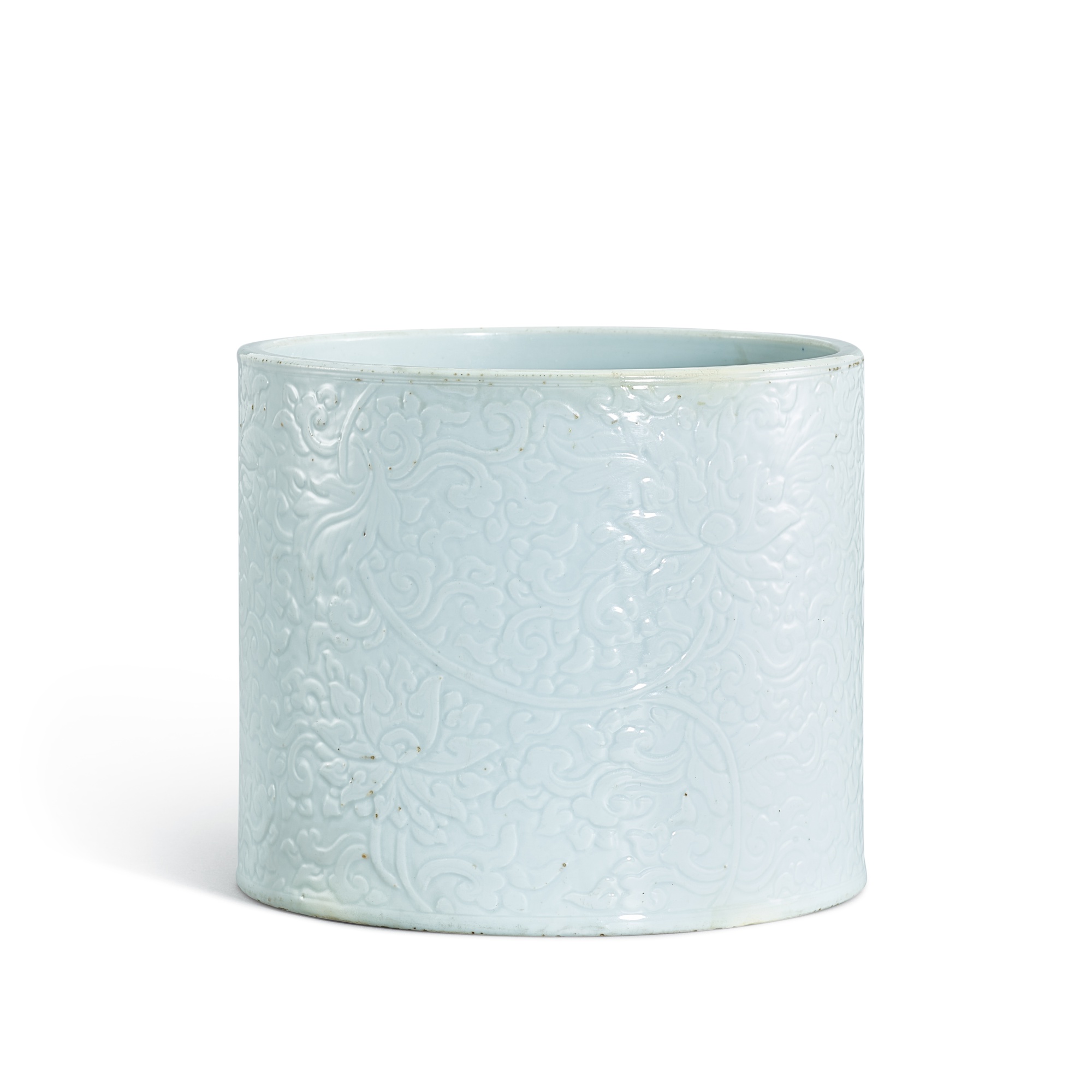 A carved white-glazed 'lotus' brushpot, — A carved white-glazed 'lotus' brushpot, Qing dynasty, Kangxi period 清康熙 白釉刻纏枝蓮紋筆筒 《成化年製》仿款