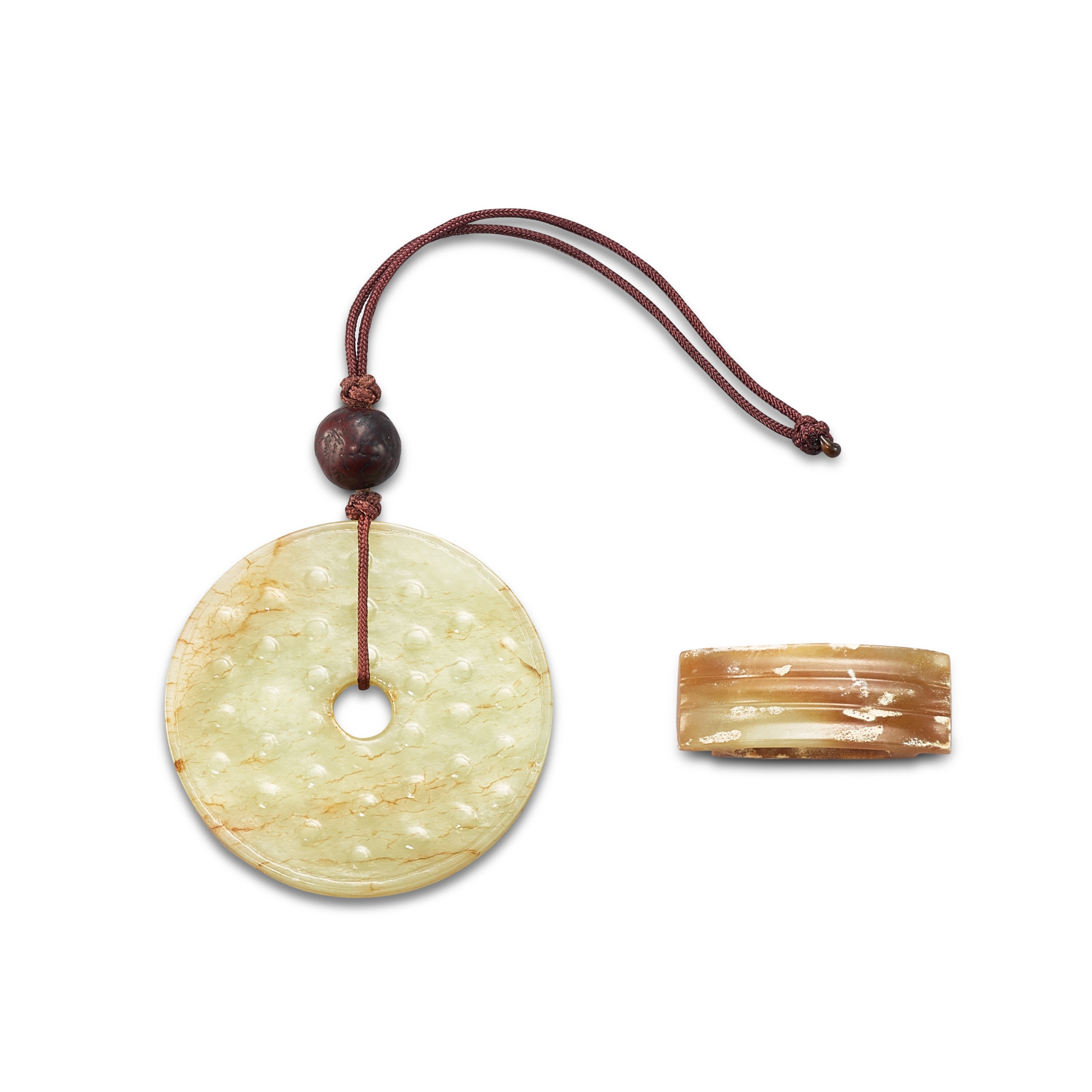 A jade scabbard slide, Late Warring States period and — A jade scabbard slide, Late Warring States period and a white jade bi disc, Ming dynasty 戰國晚期 玉劍璏 及 明 乳丁紋玉璧