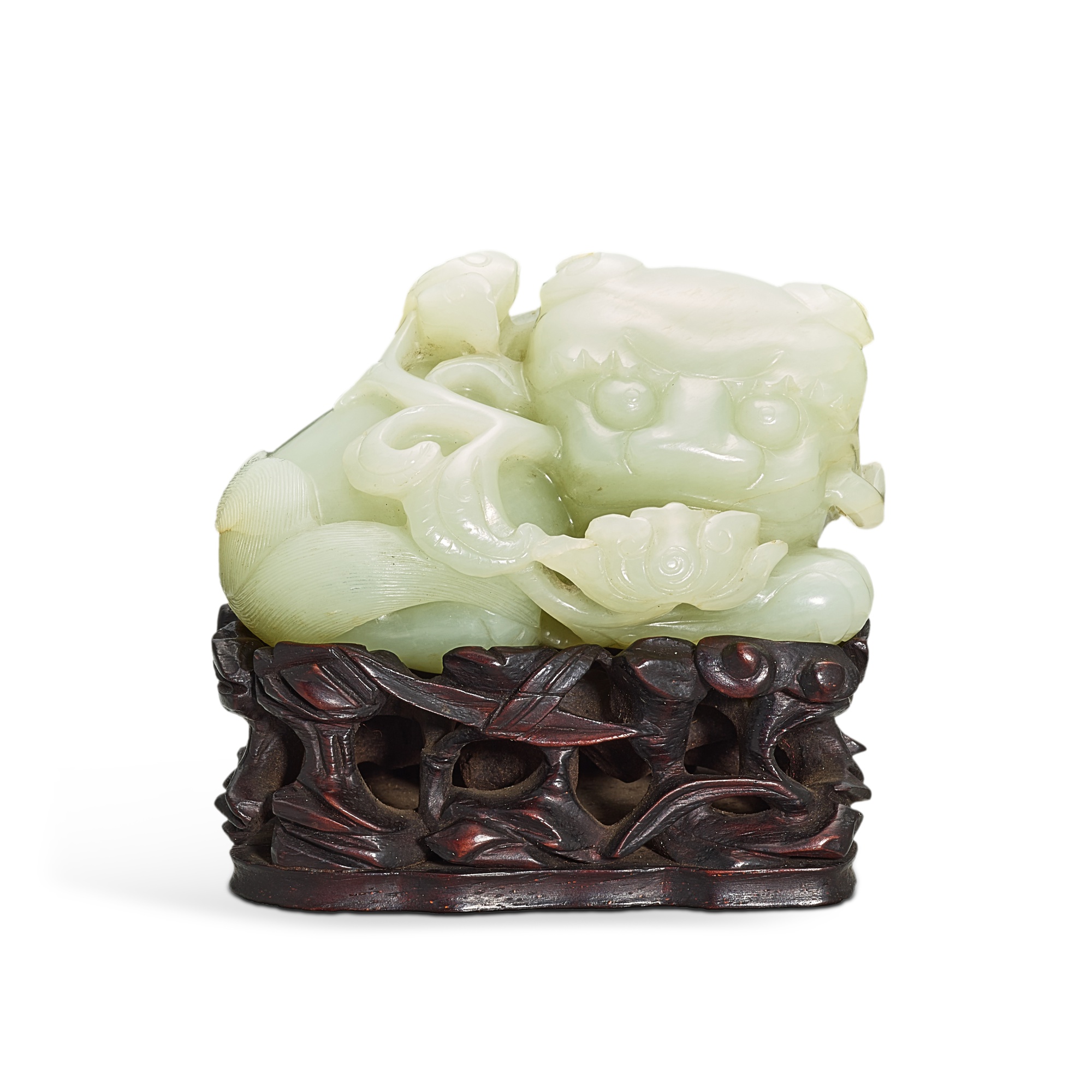 A white jade lion, — A white jade lion, 17th - 18th century 十七至十八世紀 白玉臥獅