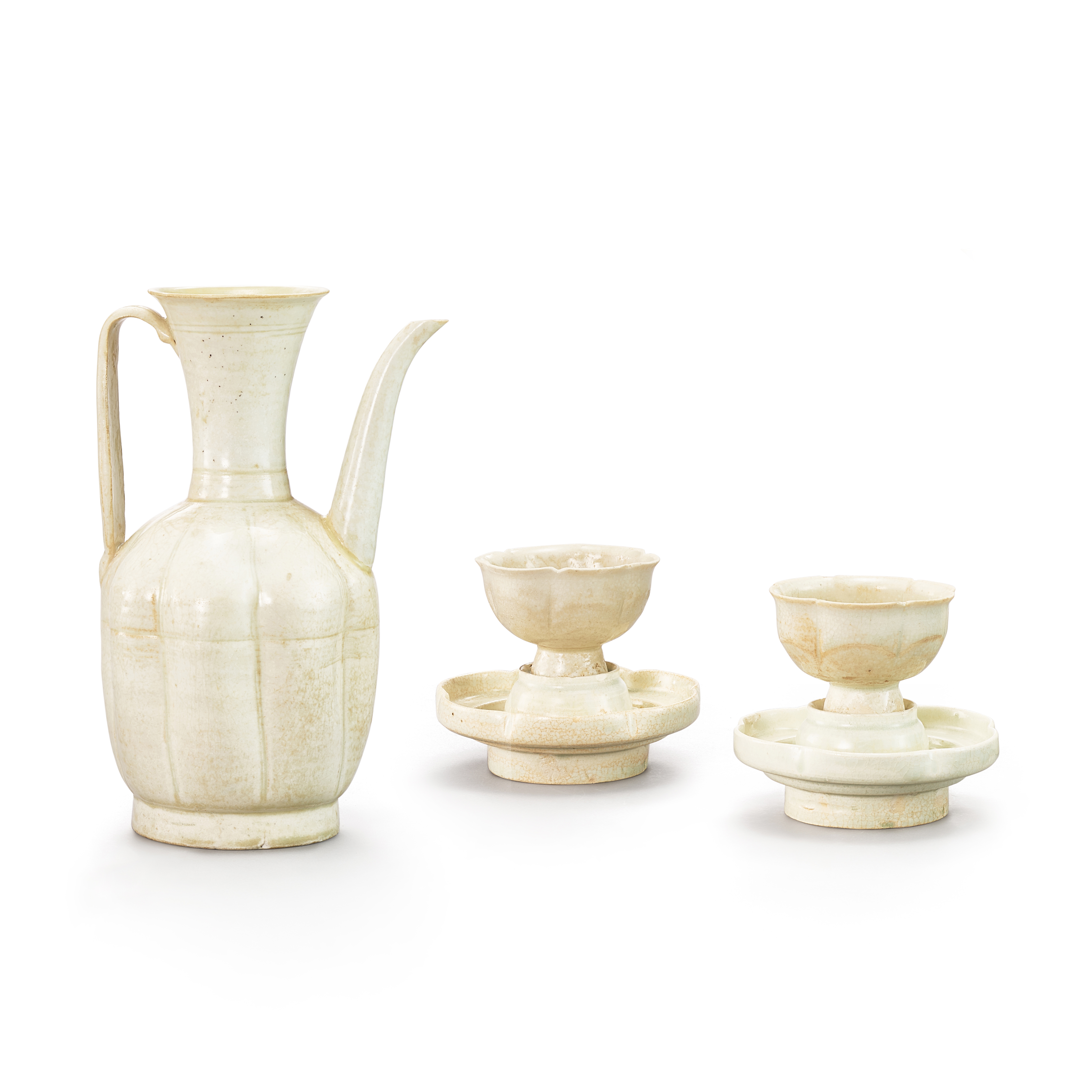 A Qingbai ewer and a pair of 'floral' cups and cup stands, — A Qingbai ewer and a pair of 'floral' cups and cup stands, Song dynasty 宋　青白釉執壺一件、剔花盃及盃托一對