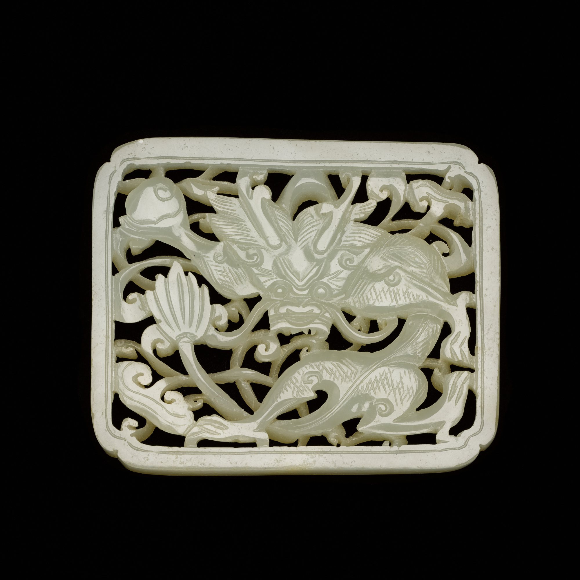 A reticulated white jade 'dragon' plaque, — 明 白玉鏤雕龍紋帶板