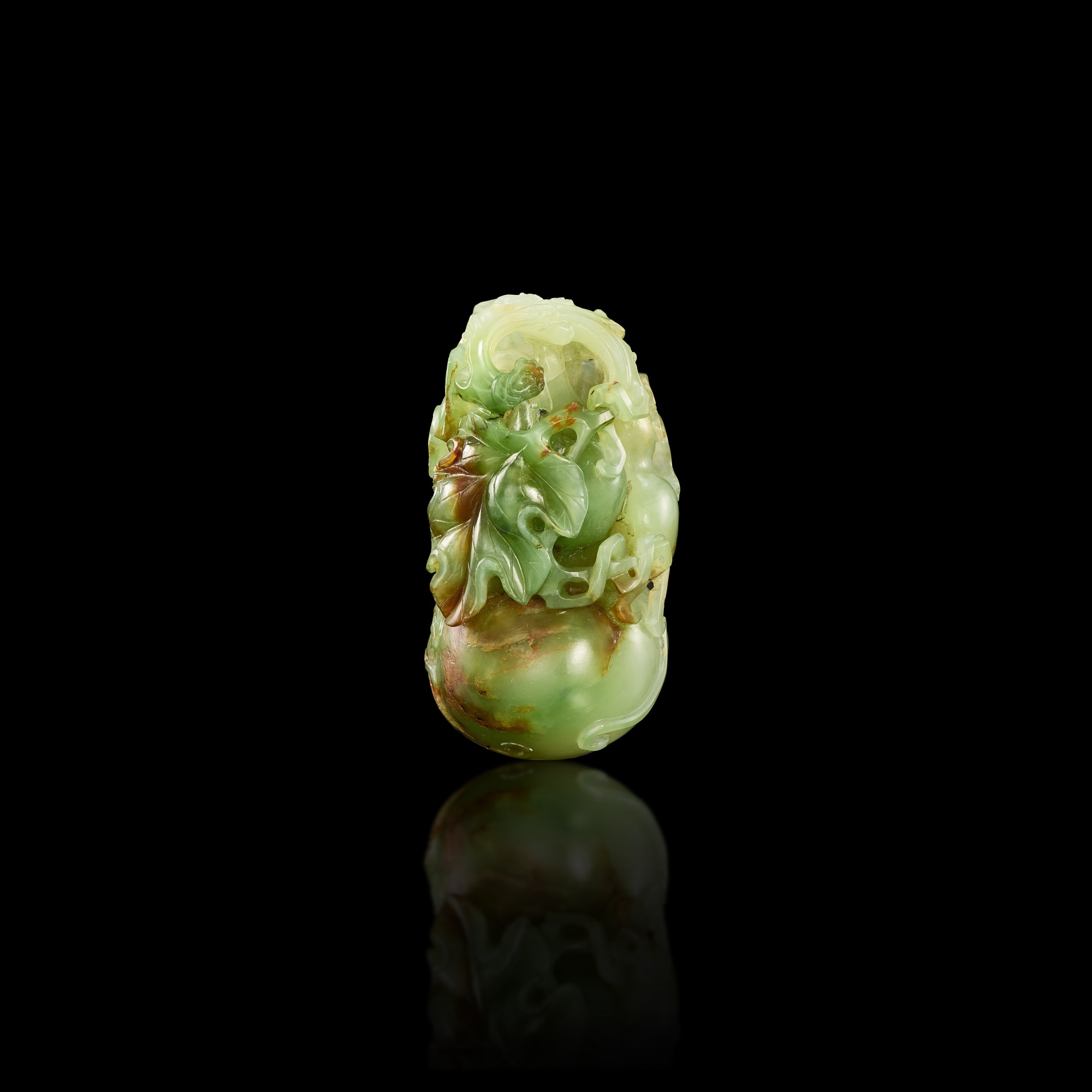 A pale green and russet jade 'double-gourd' carving, — A pale green and russet jade 'double-gourd' carving, Qing dynasty, 18th century 清十八世紀 淺青玉葫蘆把件