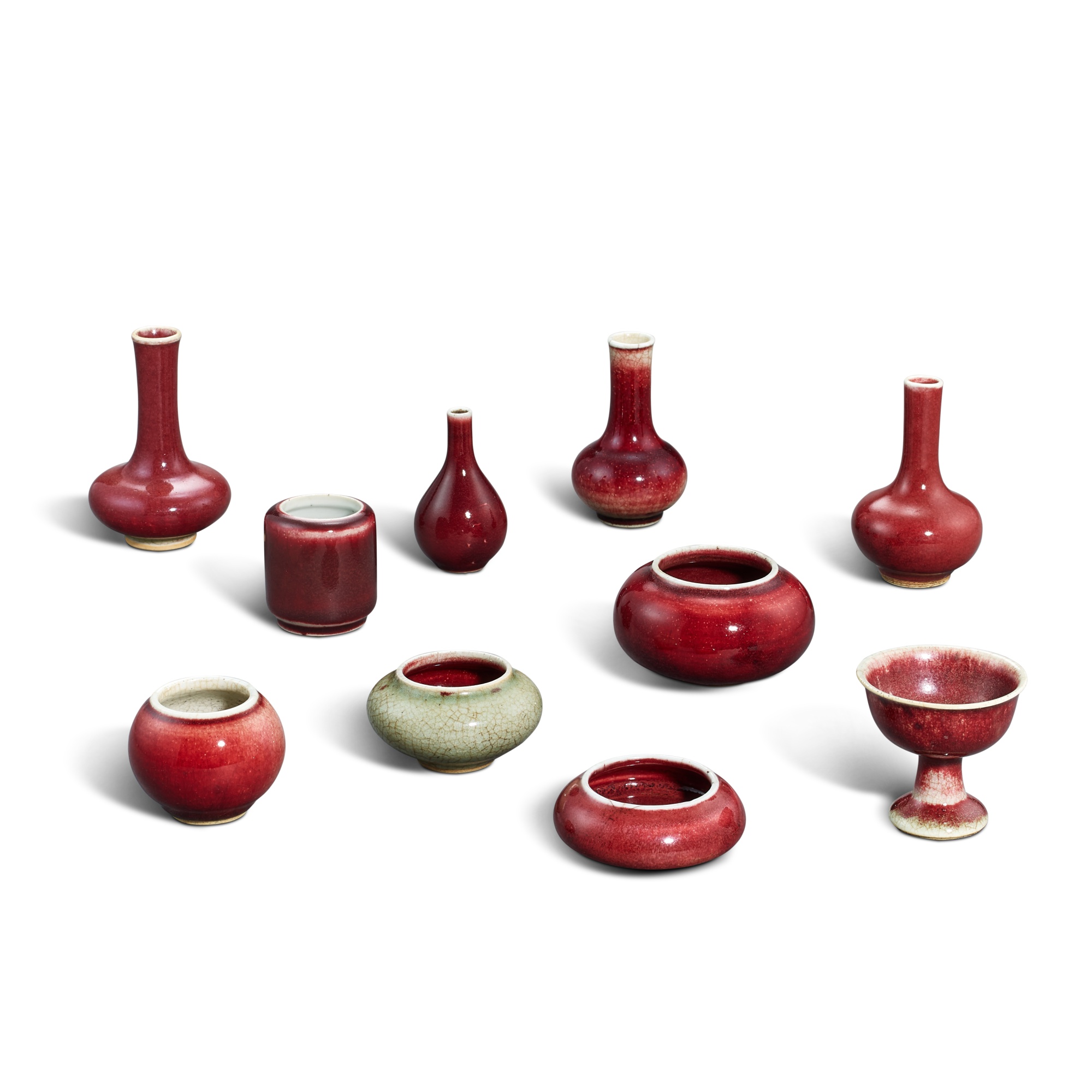 Ten small Langyao red-glazed ceramics — 清十八至十九世紀 郎窰紅釉小瓶、水丞及高足盃 一組十件