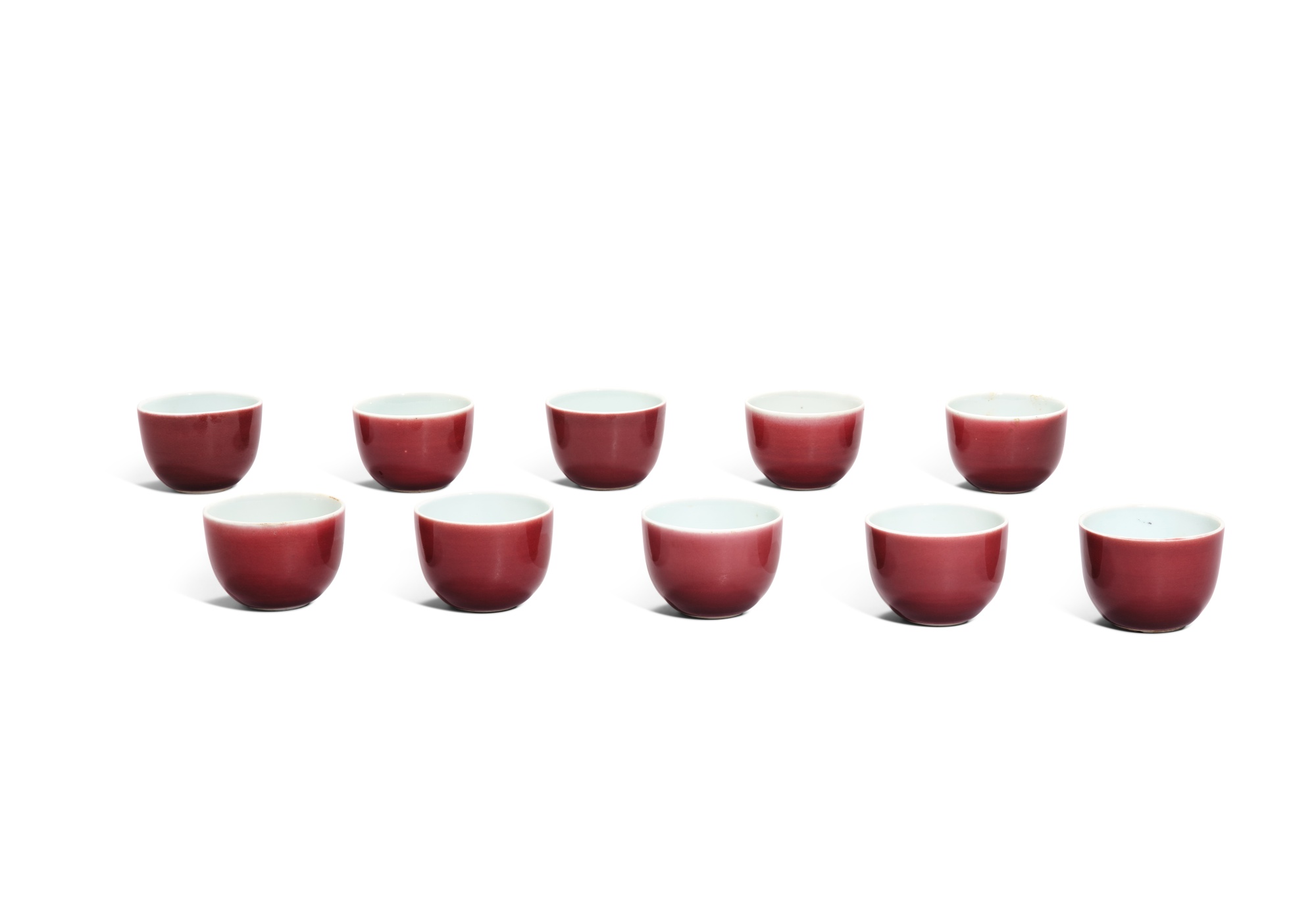 Ten small red-glazed cups