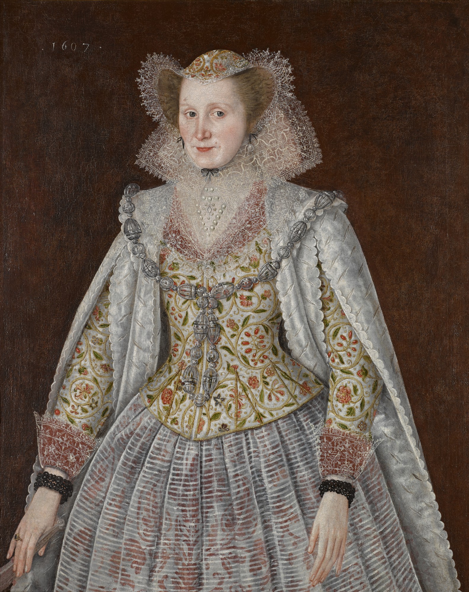 Unknown — Portrait of a lady, three-quarter length, wearing an embroidered waistcoat, with lace collar and cuffs