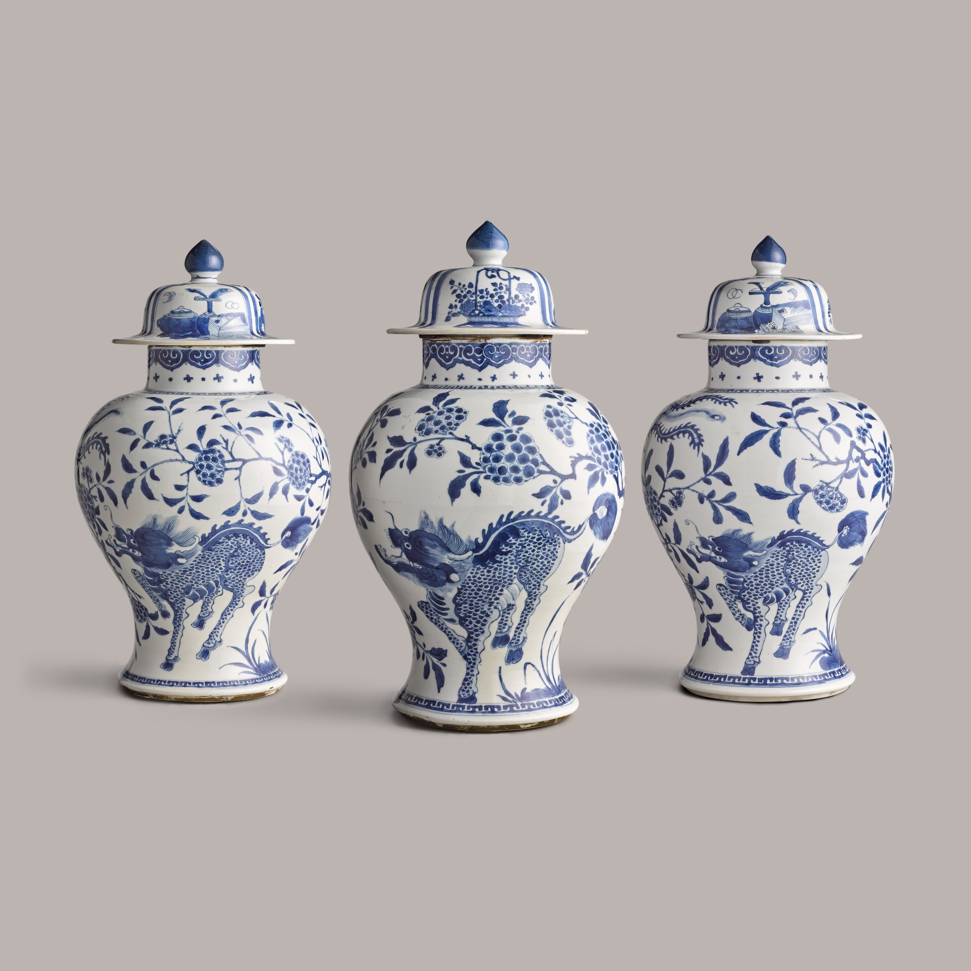 Three blue and white baluster vases and covers — 清康熙 青花瑞獸圖大蓋罐一組三件