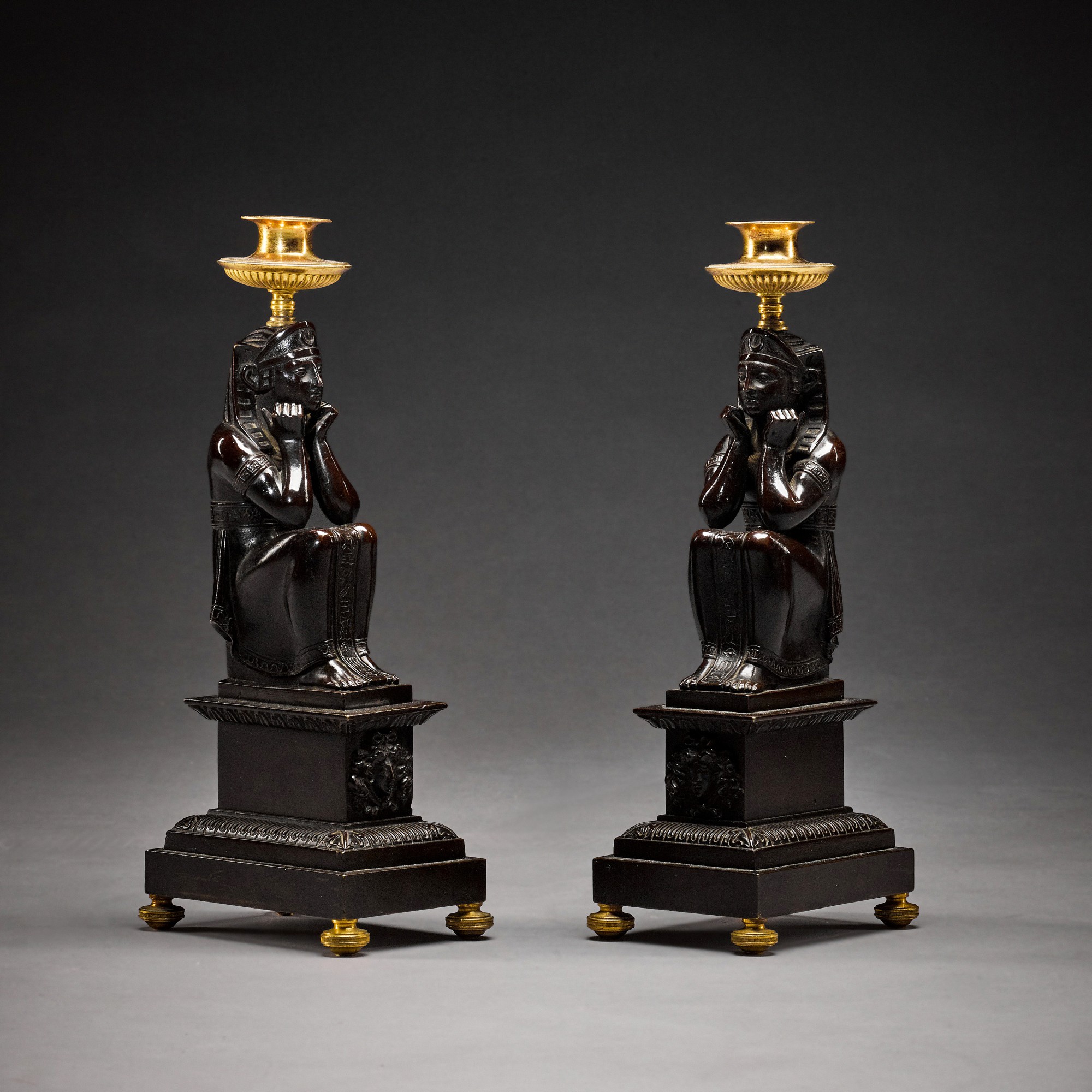 Unknown — A pair of Regency gilt and patinated bronze candlesticks, circa 1810
