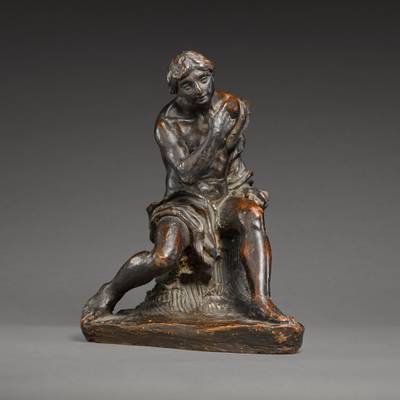 Young Man resting on a tree stump 