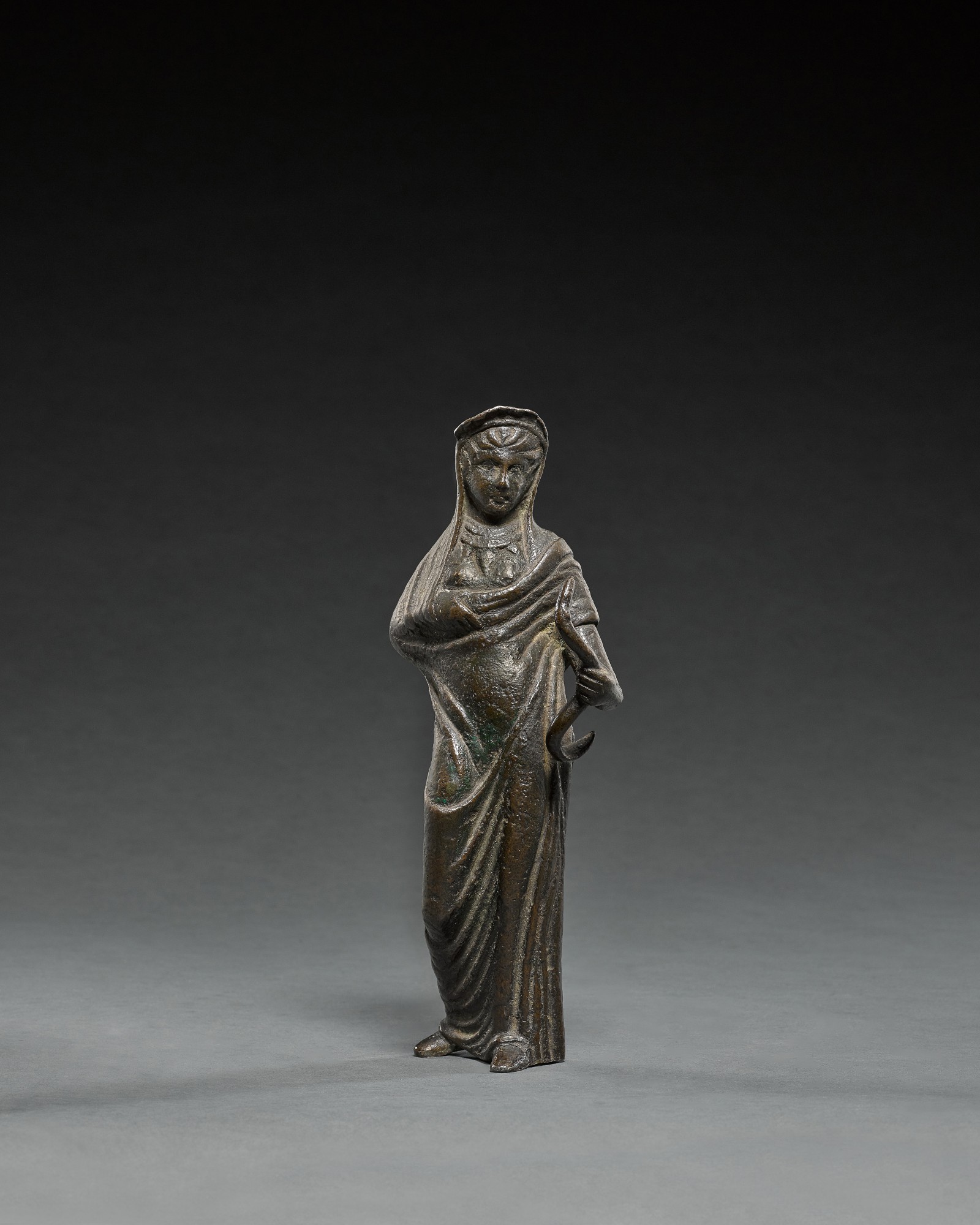 Etruscan Bronze Figure of a Goddess or Votary holding a Serpent — Etruscan Bronze Figure of a Goddess or Votary holding a Serpent, circa 3rd Century B.C.