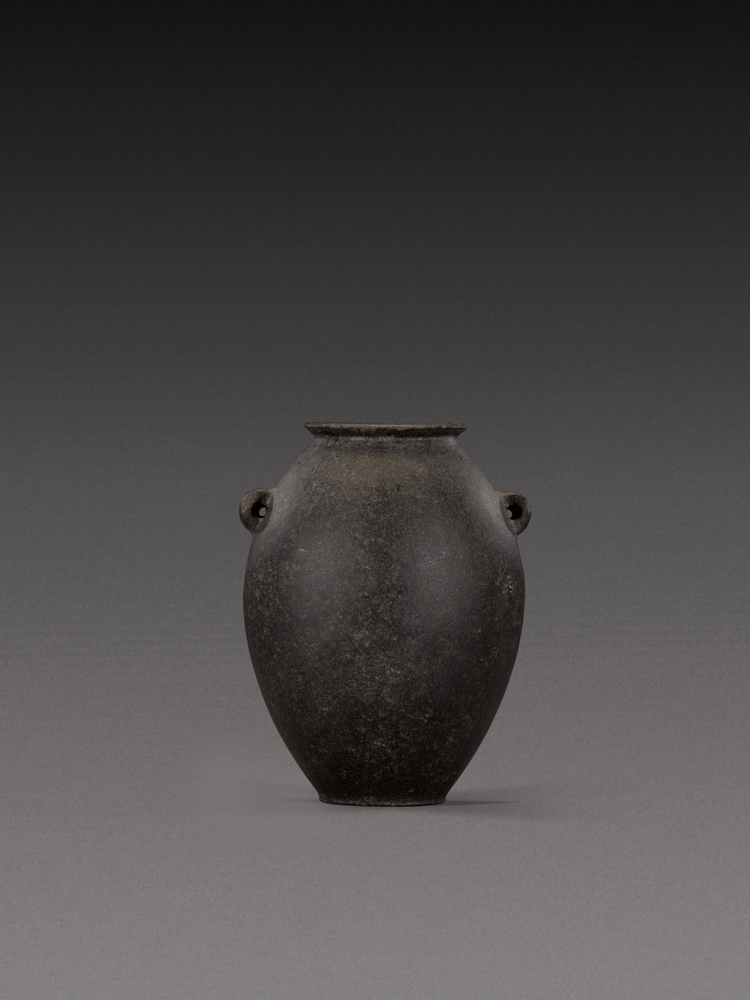 An Egyptian Basalt or Graywacke Jar — An Egyptian Basalt or Graywacke Jar, Predynastic Period (Naqada II)/1st Dynasty, circa 3500-2900 B.C.