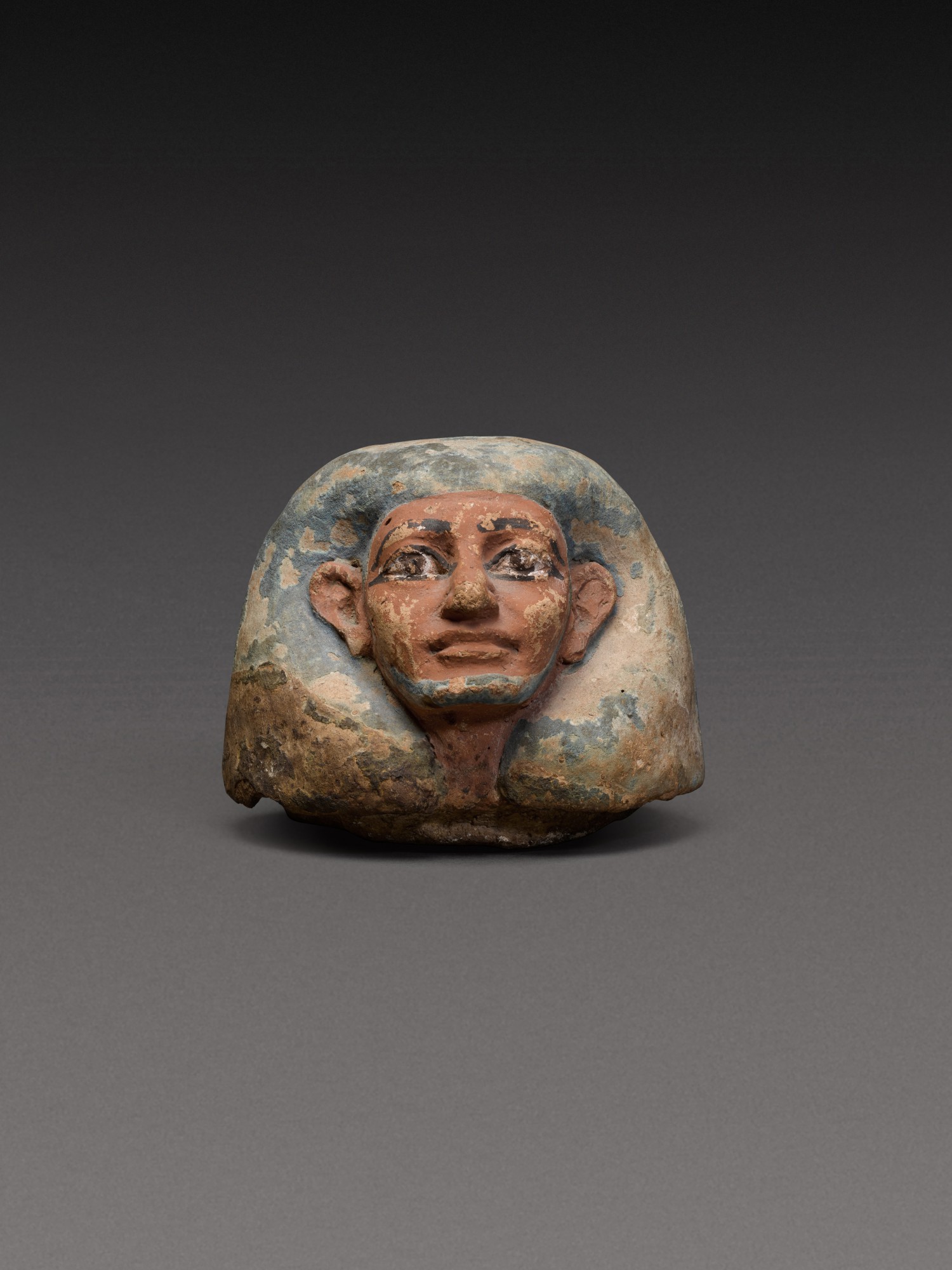 An Egyptian Polychrome Terracotta Canopic Jar Lid — An Egyptian Polychrome Terracotta Canopic Jar Lid, 18th Dynasty, 1540-1292 B.C.