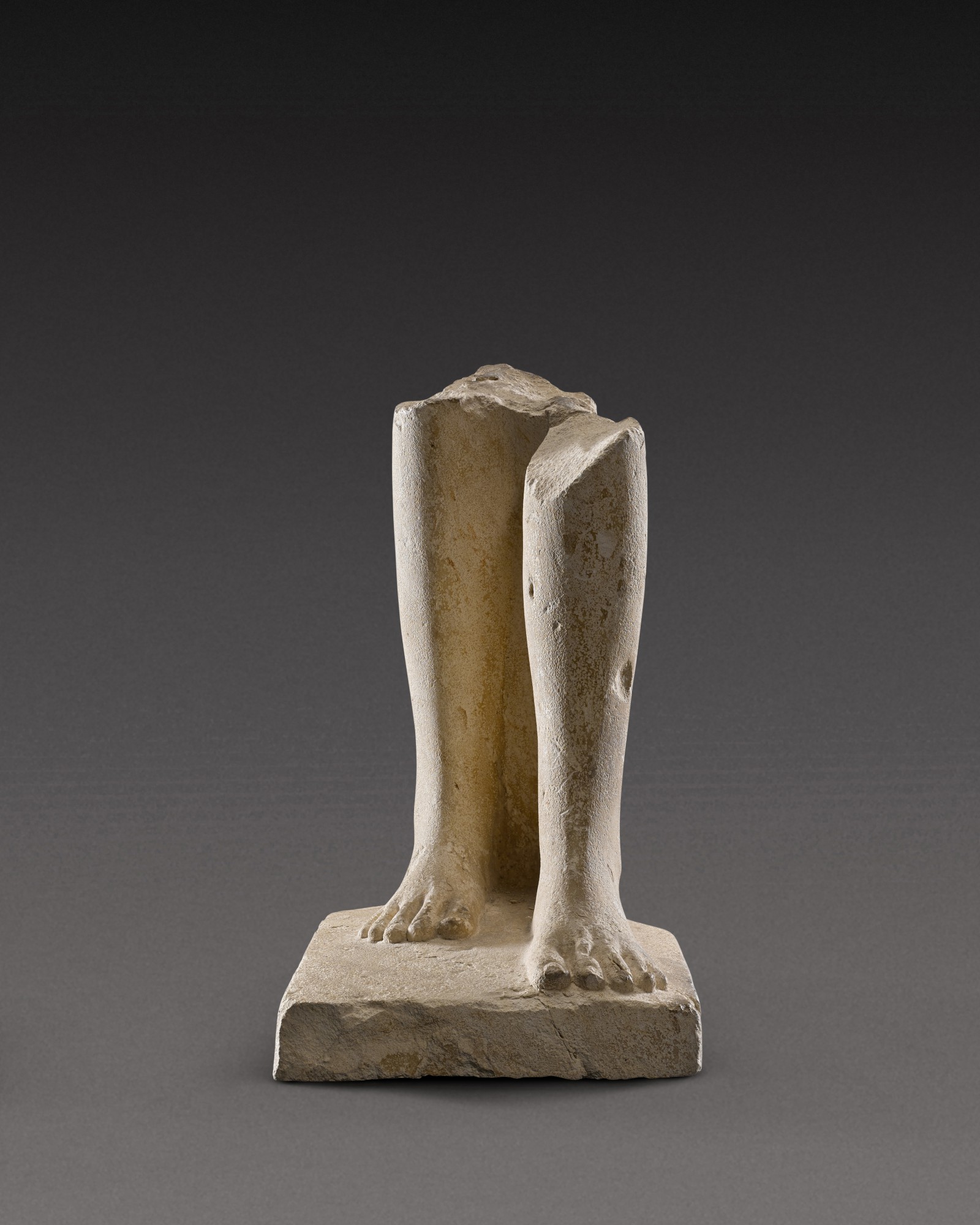 An Egyptian Limestone Statue Fragment, 30th Dynasty/Ptolemaic Period, 380-30 B.C.