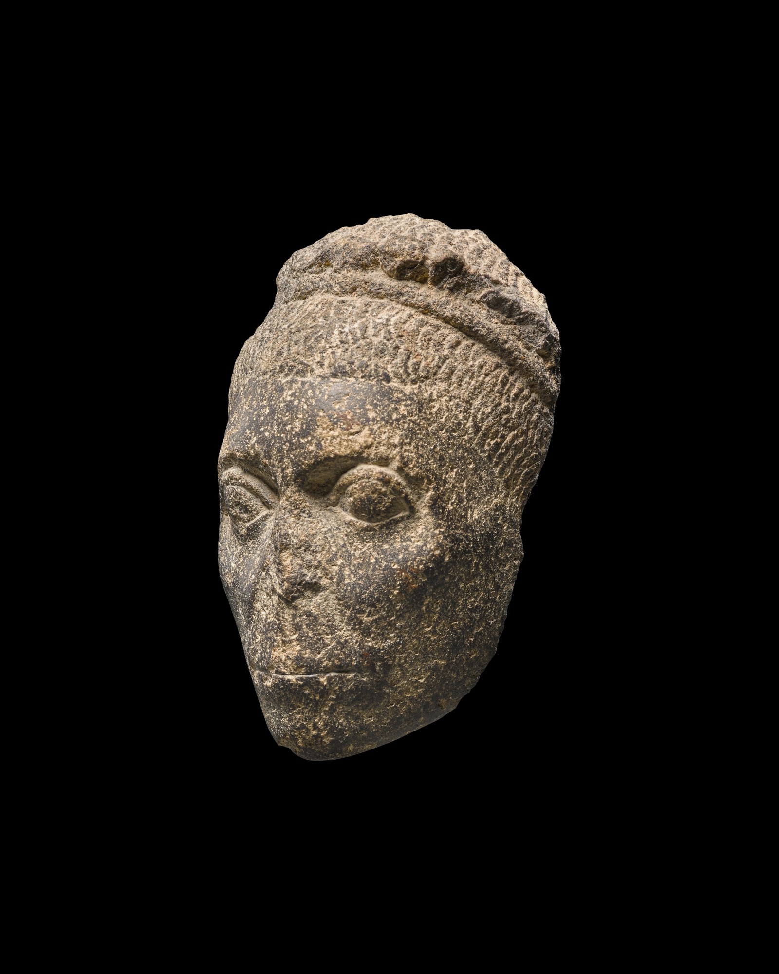 A Fragmentary Egyptian Basalt Head of a Man — A Fragmentary Egyptian Basalt Head of a Man, Roman Period, circa 1st/2nd Century A.D.