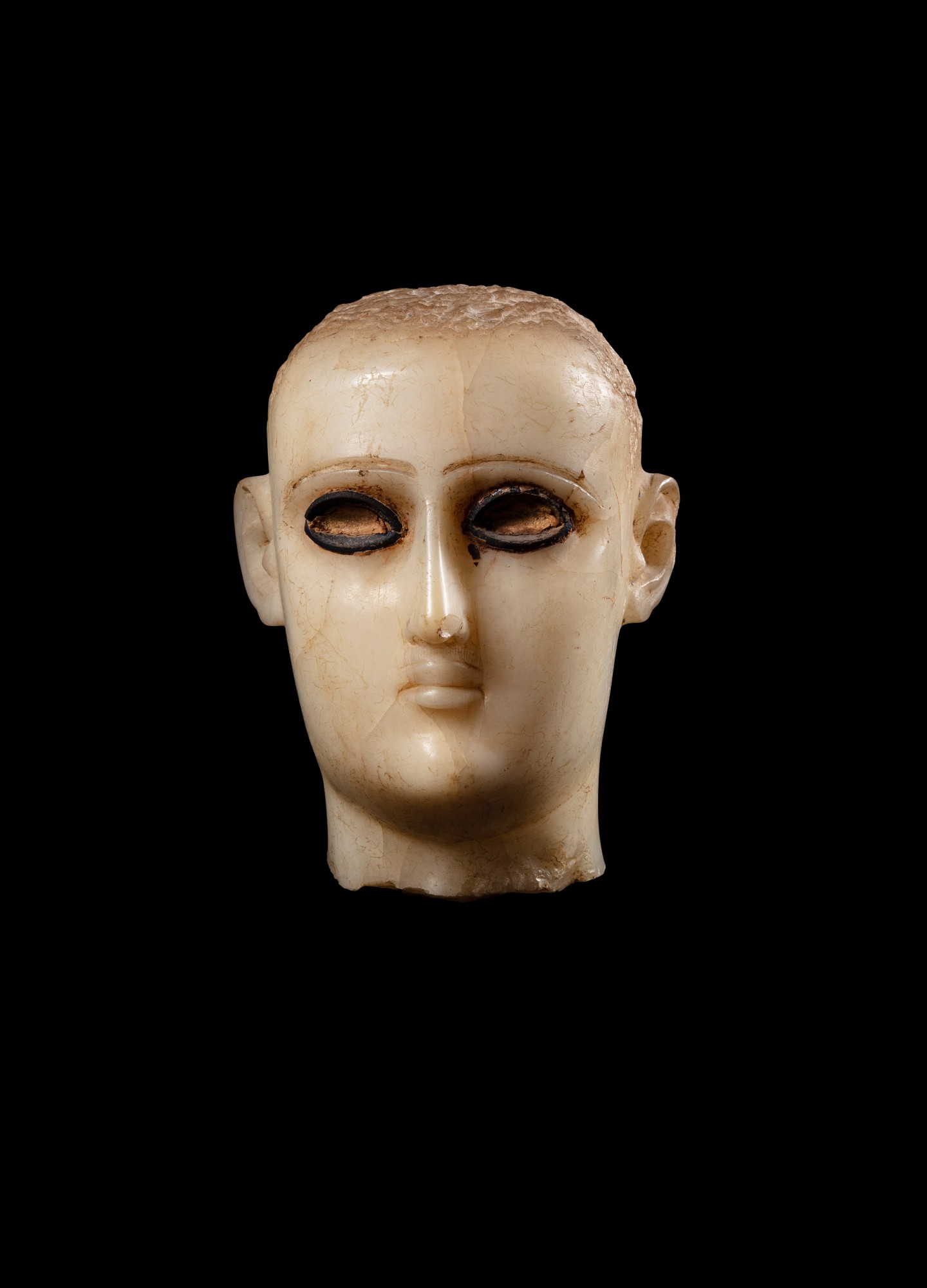 A South Arabian Alabaster Head of a Man, Qataban — A South Arabian Alabaster Head of a Man, Qataban, 3rd Century B.C./1st Century A.D.