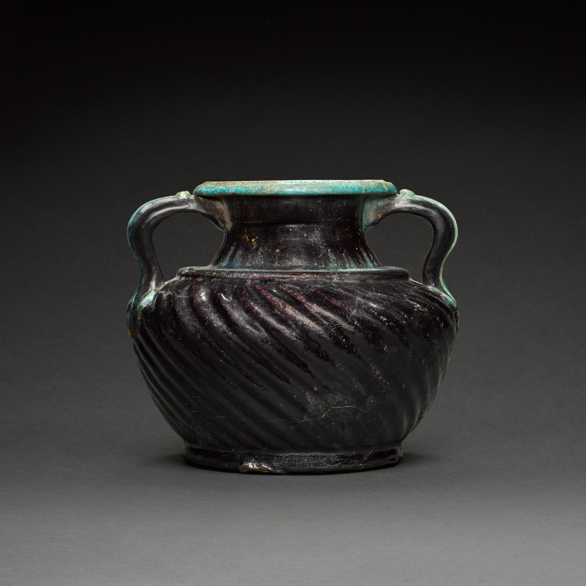 An Egyptian Deep Aubergine and Turquoise Faience Vase — An Egyptian Deep Aubergine and Turquoise Faience Vase, Roman Period, circa 1st Century A.D.