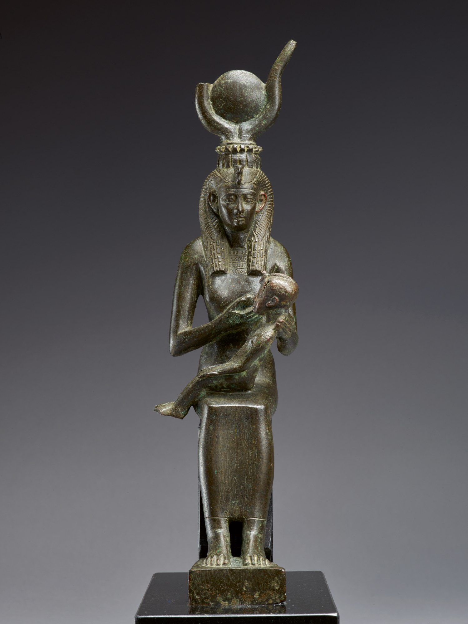 An Egyptian Bronze Figure of Isis with Horus — An Egyptian Bronze Figure of Isis with Horus, 26th Dynasty, 664-525 B.C.